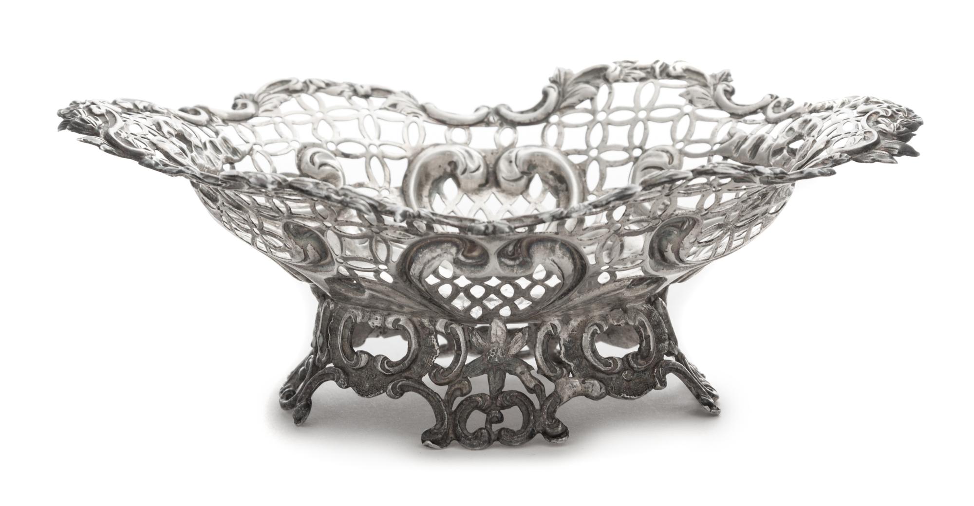 A Victorian Silver Basket, Likely William Comyns, London, 1890, having a pierced body with a C-scroll and floral decorated rim and base