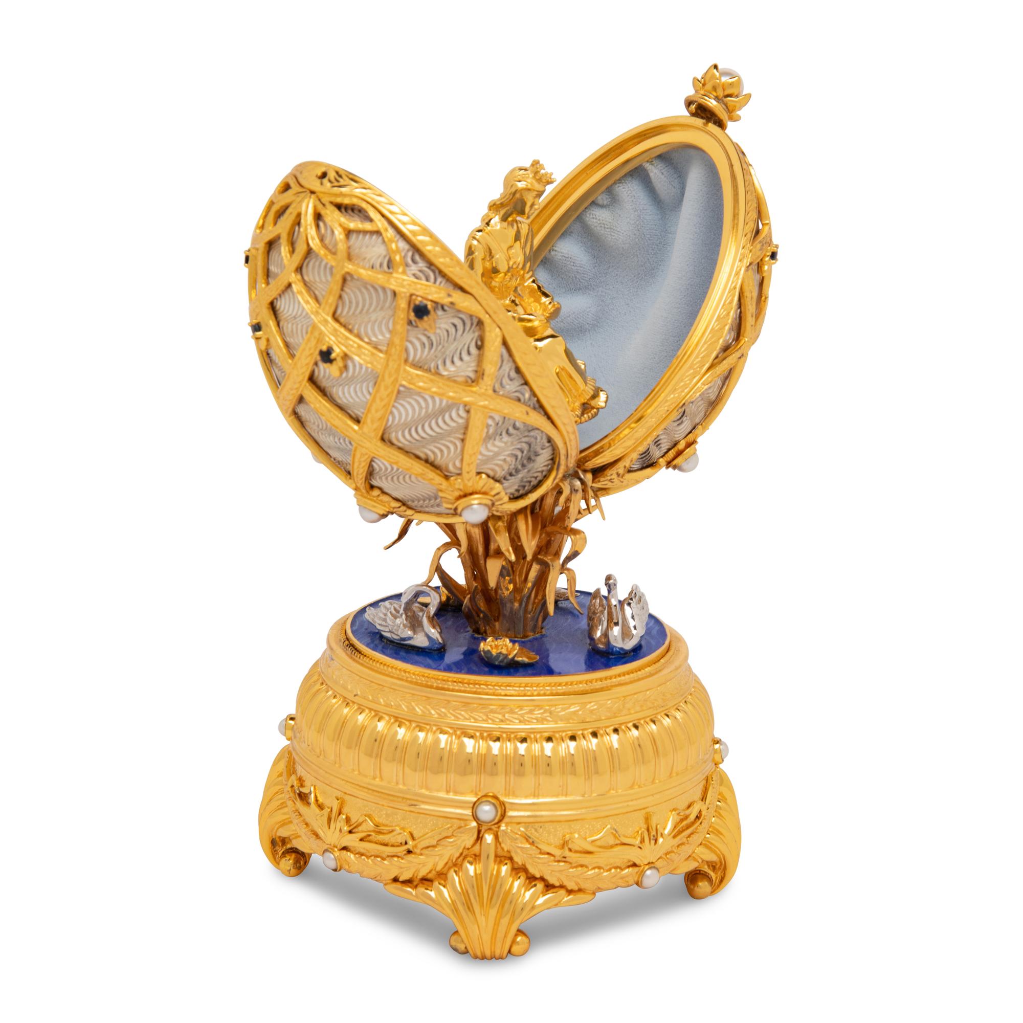 A Silver, Gilt and Enamel Decorated Swan Lake Egg-Form Music Box