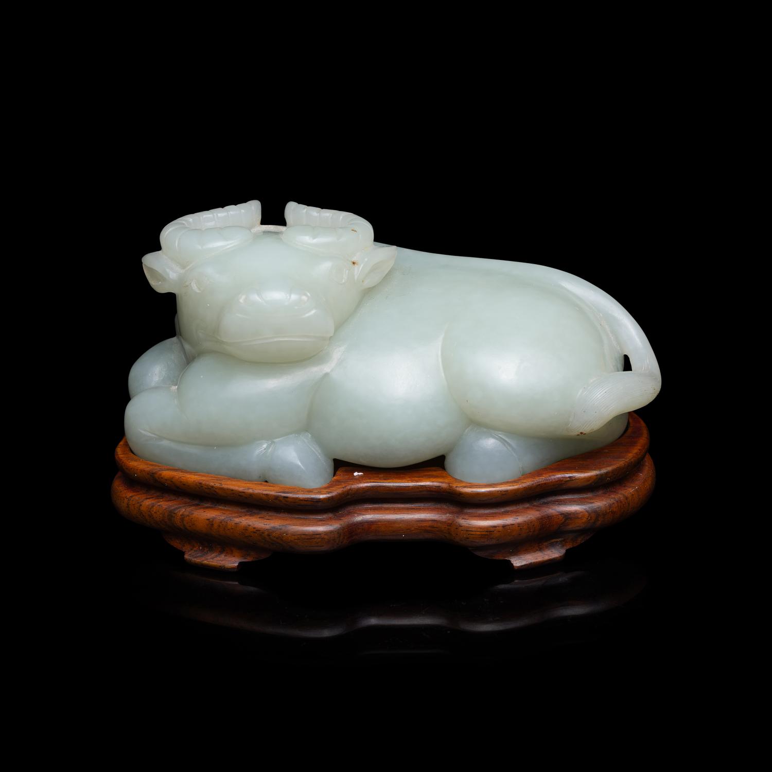 A Chinese Pale Celadon Jade Figure of a Recumbent Buffalo, Qing Dynasty 清 青玉臥牛
