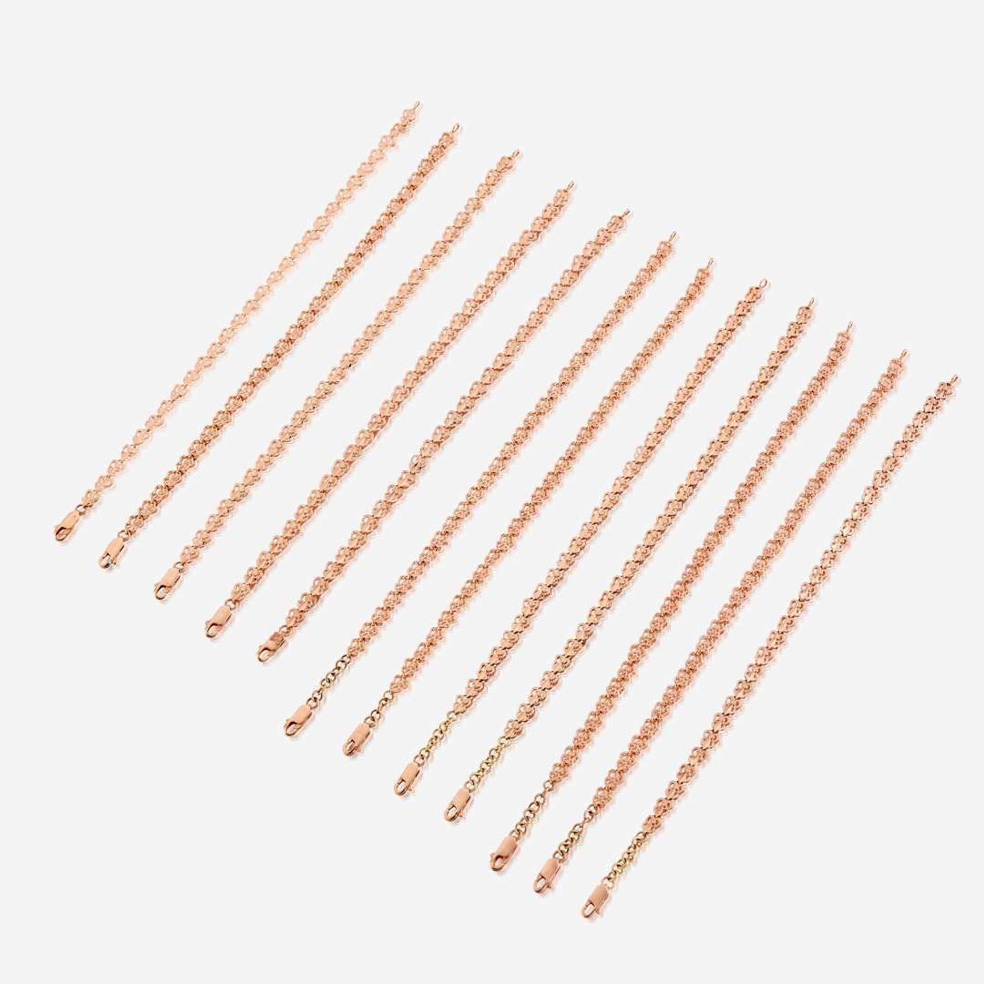 A collection of twelve fourteen karat rose gold bracelets