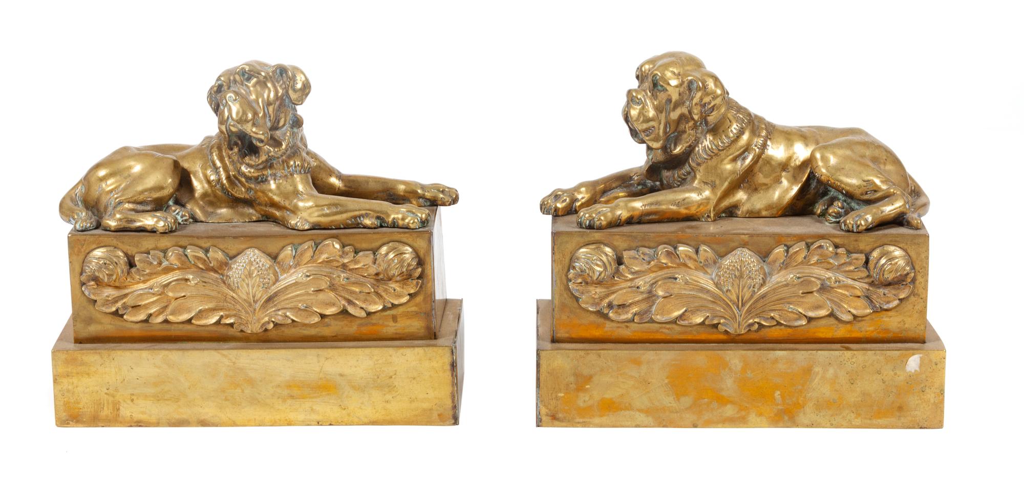 A Pair of Brass Mastiff Chenets Width 11 1/2 inches.