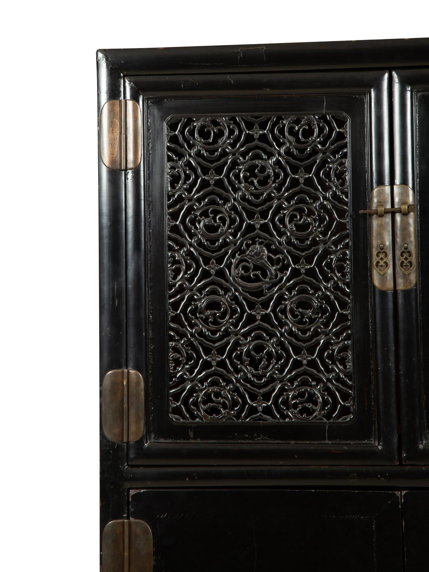 A Chinese Black Lacquer Cabinet with Pierce-carved Upper Door Panels