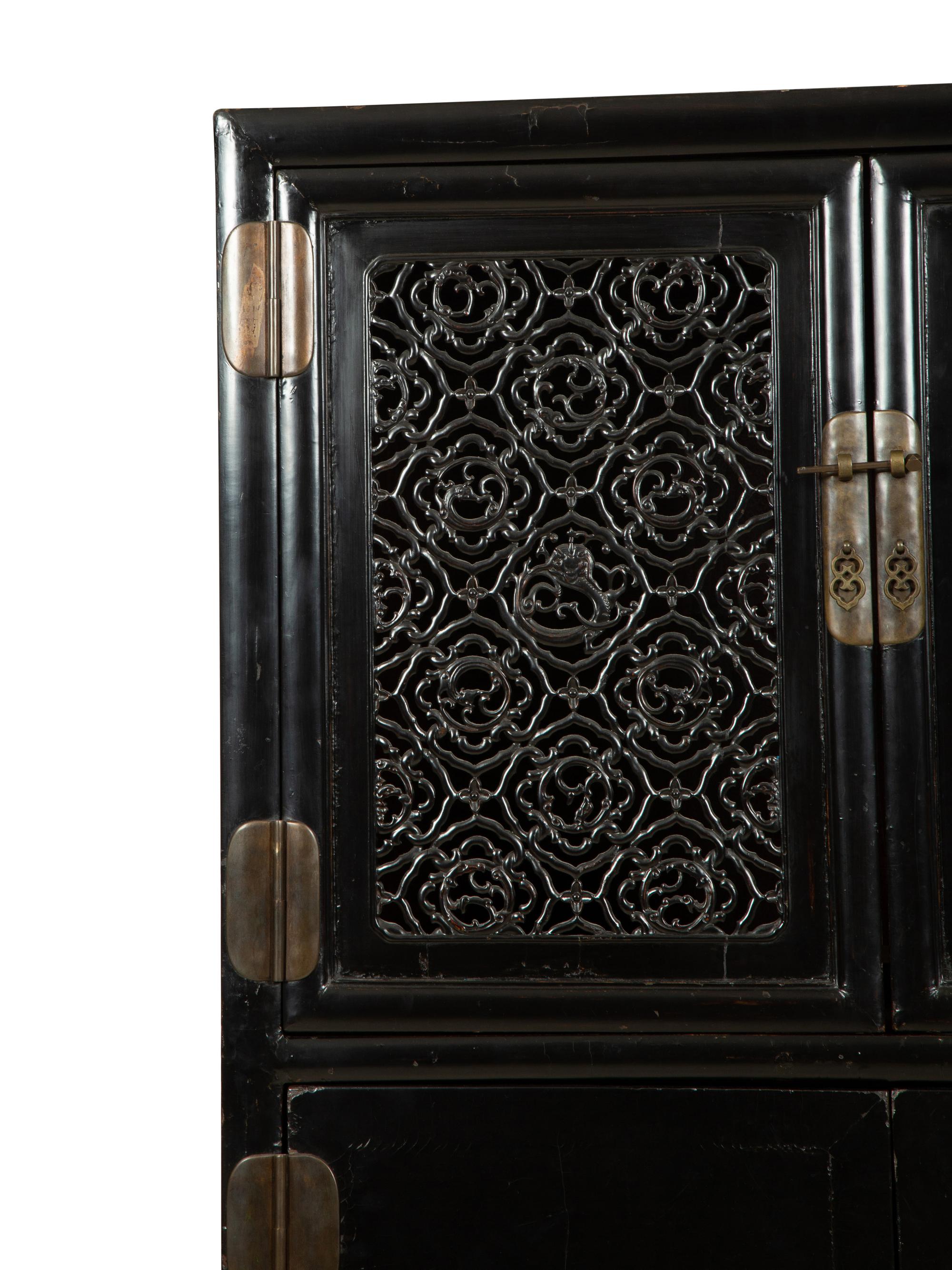 A Chinese Black Lacquer Cabinet with Pierce-carved Upper Door Panels