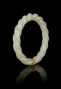 A Carved Celadon Jade 'Robe Twist' Bangle Diameter 3 inches. — 19TH/20TH CENTURY
