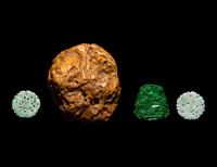 A Chinese Soapstone Boulder and Three Green Jade and Jadeite Pendants