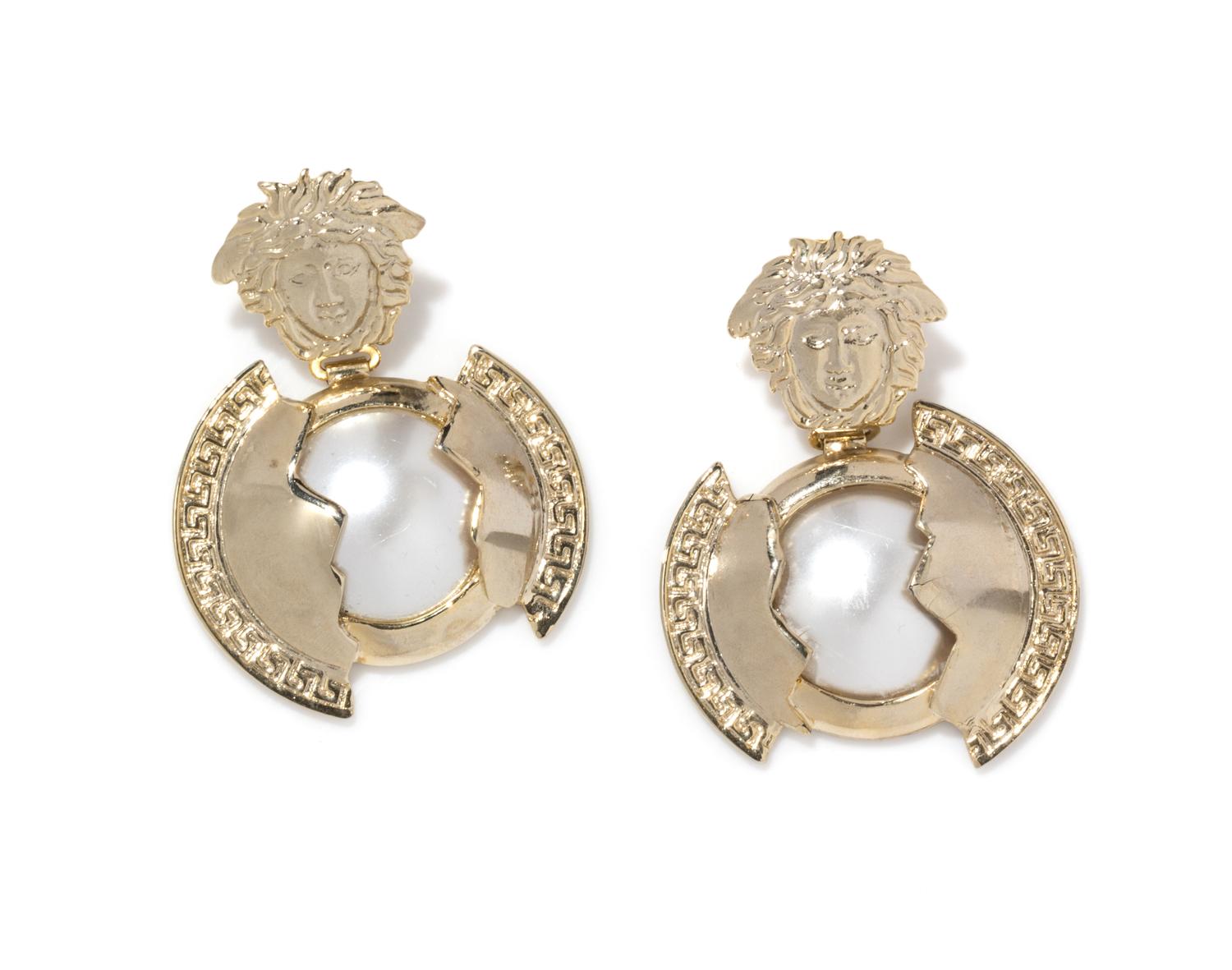 A Pair of Gianni Versace Faux Pearl and Medusa Earclips, 2" x 3".