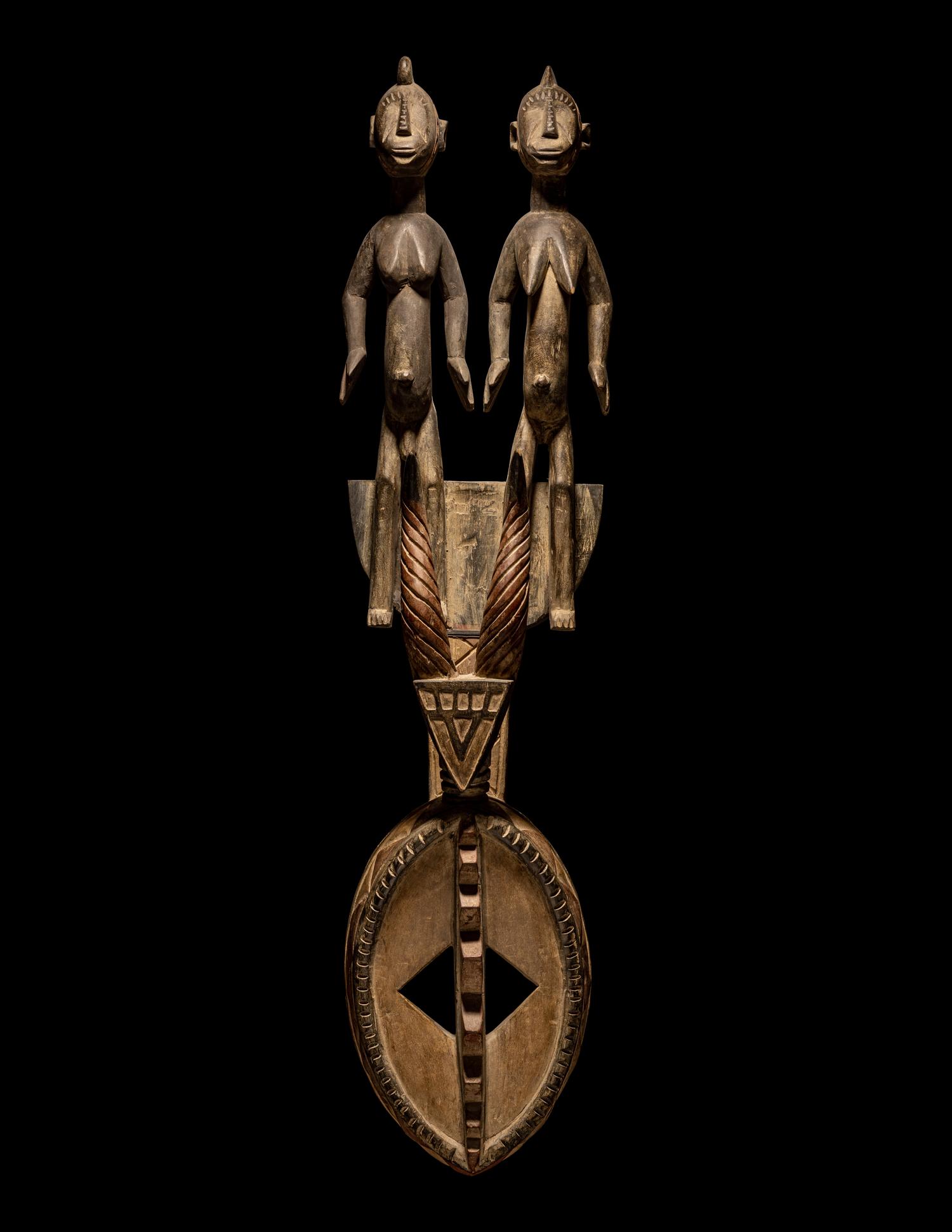 A Bamana Wood Horned Mask with Figures