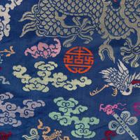 A Chinese Blue Ground Brocade 'Dragon' Robe, Jifu, Late Qing Dynasty 清晚期 藍地織錦云龍紋吉服