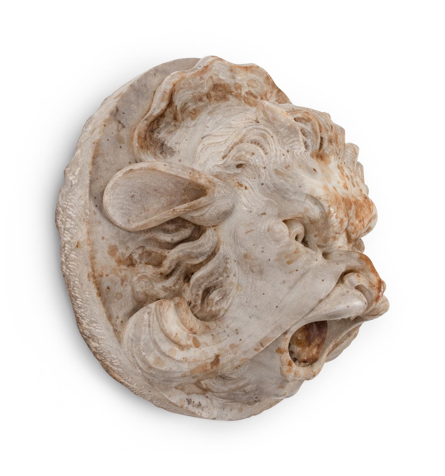A Continental Carved Stone Grotesque Mask