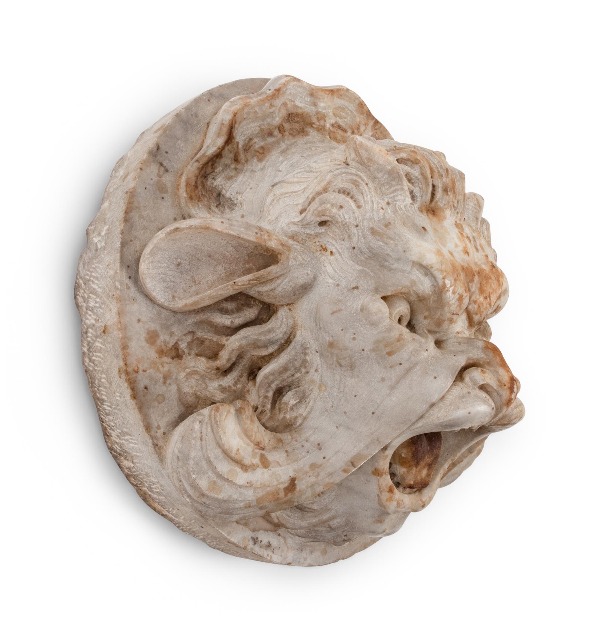 A Continental Carved Stone Grotesque Mask
