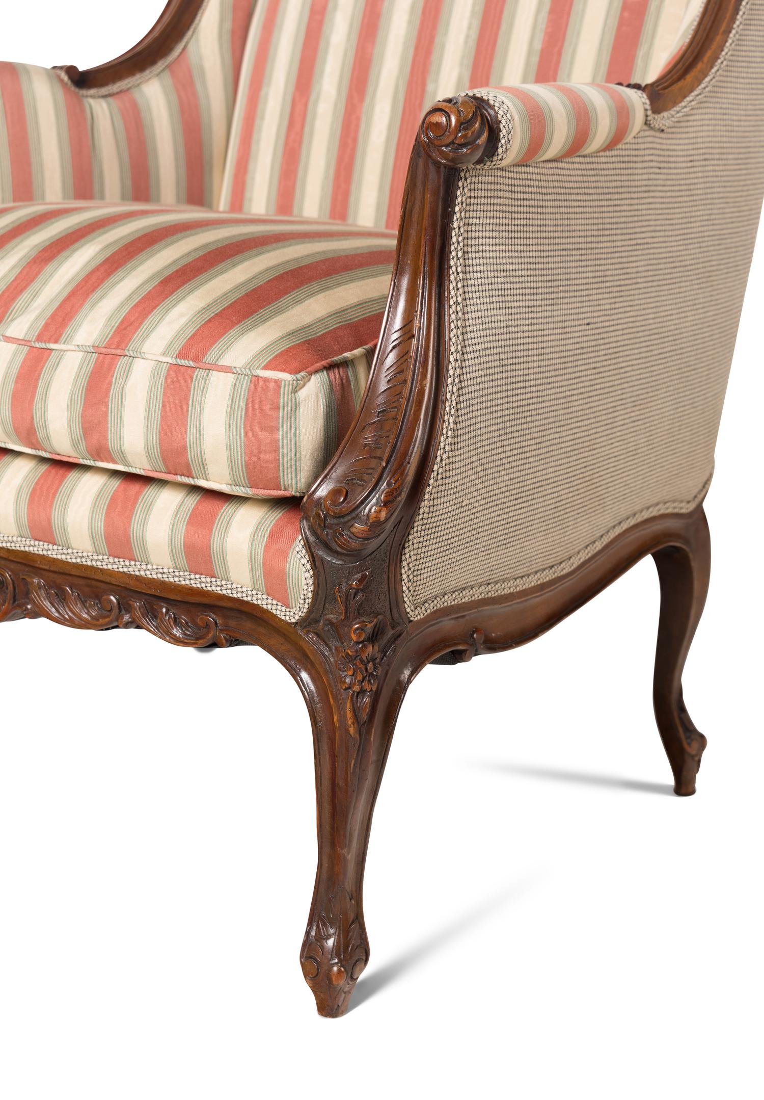 A Pair of Louis XV Style Carved Wingback Armchairs