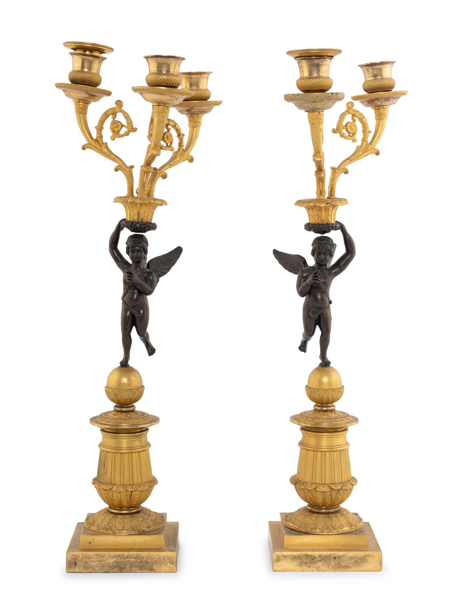 A Pair of Empire Style Gilt and Patinated Bronze Figural Candelabra