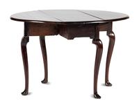 A Queen Anne Carved and Figured Mahogany Drop-Leaf Slipper Foot Table