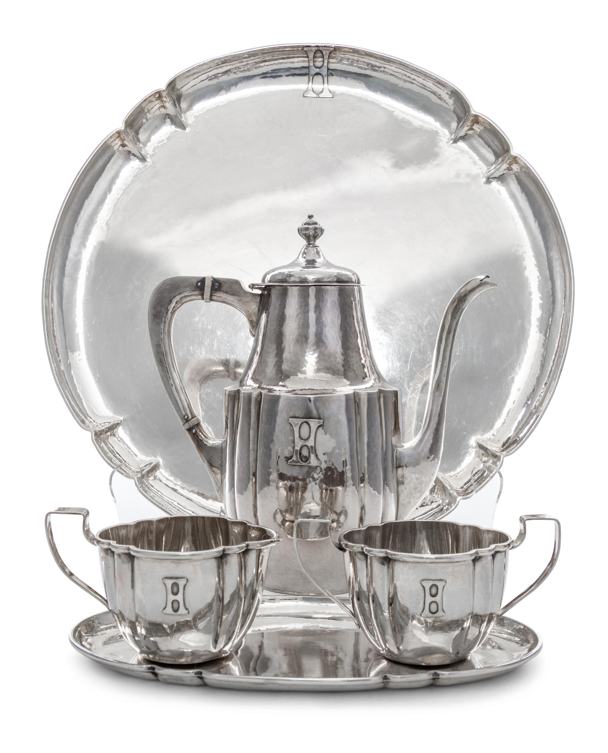 An American Arts and Crafts Silver Tea Service, Falick Novick, Chicago, IL, Early 20th Century, comprising a teapot, a creamer, a sugar