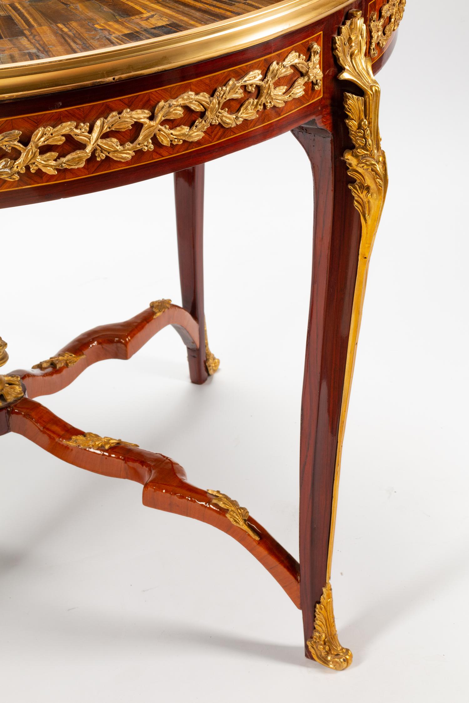 A Louis XV Style Gilt Bronze Mounted Parquetry Center Table with a Tiger's Eye Top