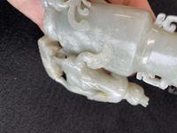 A Chinese jade "Boys, Kylin and Phoenix" vase on carved wood stand 玉雕童子凤鸟花樽及底座