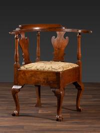 A Queen Anne Carved Walnut Knuckle-Arm and Trifid Foot Corner Chair