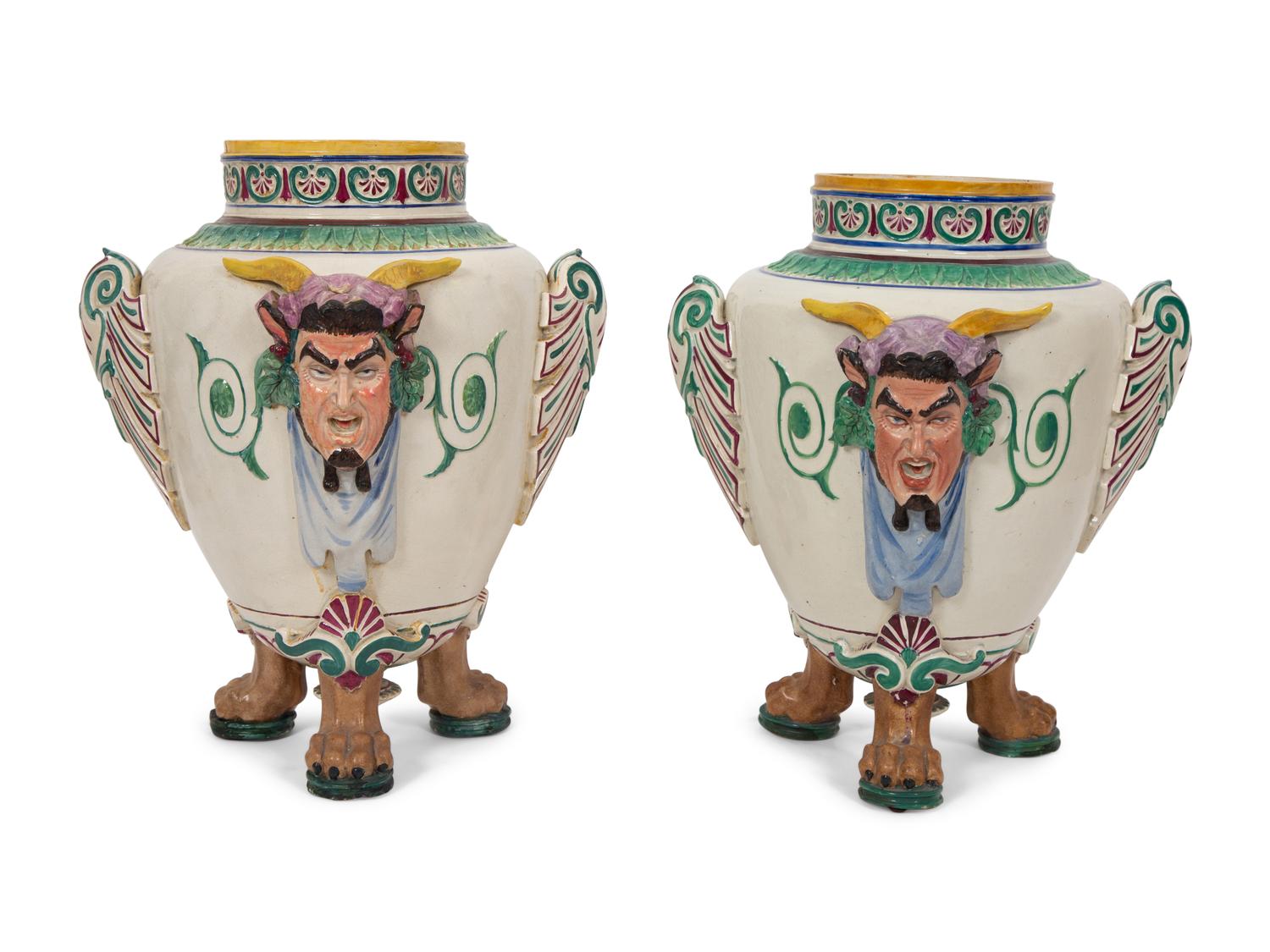 A Pair of Italian Glazed Ceramic Urns Decorated with Horned Masks and Paw Feet
