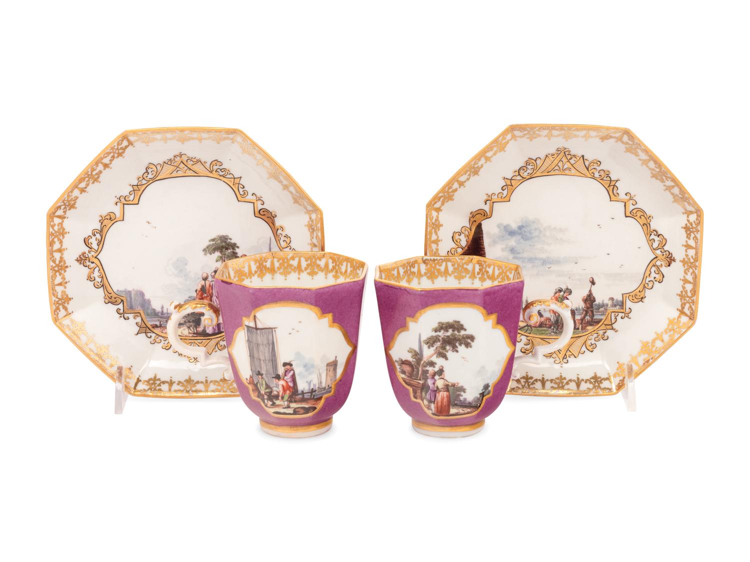 A Pair of Meissen Magenta-Ground Scenic Porcelain Teacups and Saucers