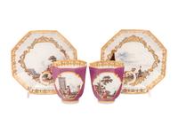A Pair of Meissen Magenta-Ground Scenic Porcelain Teacups and Saucers