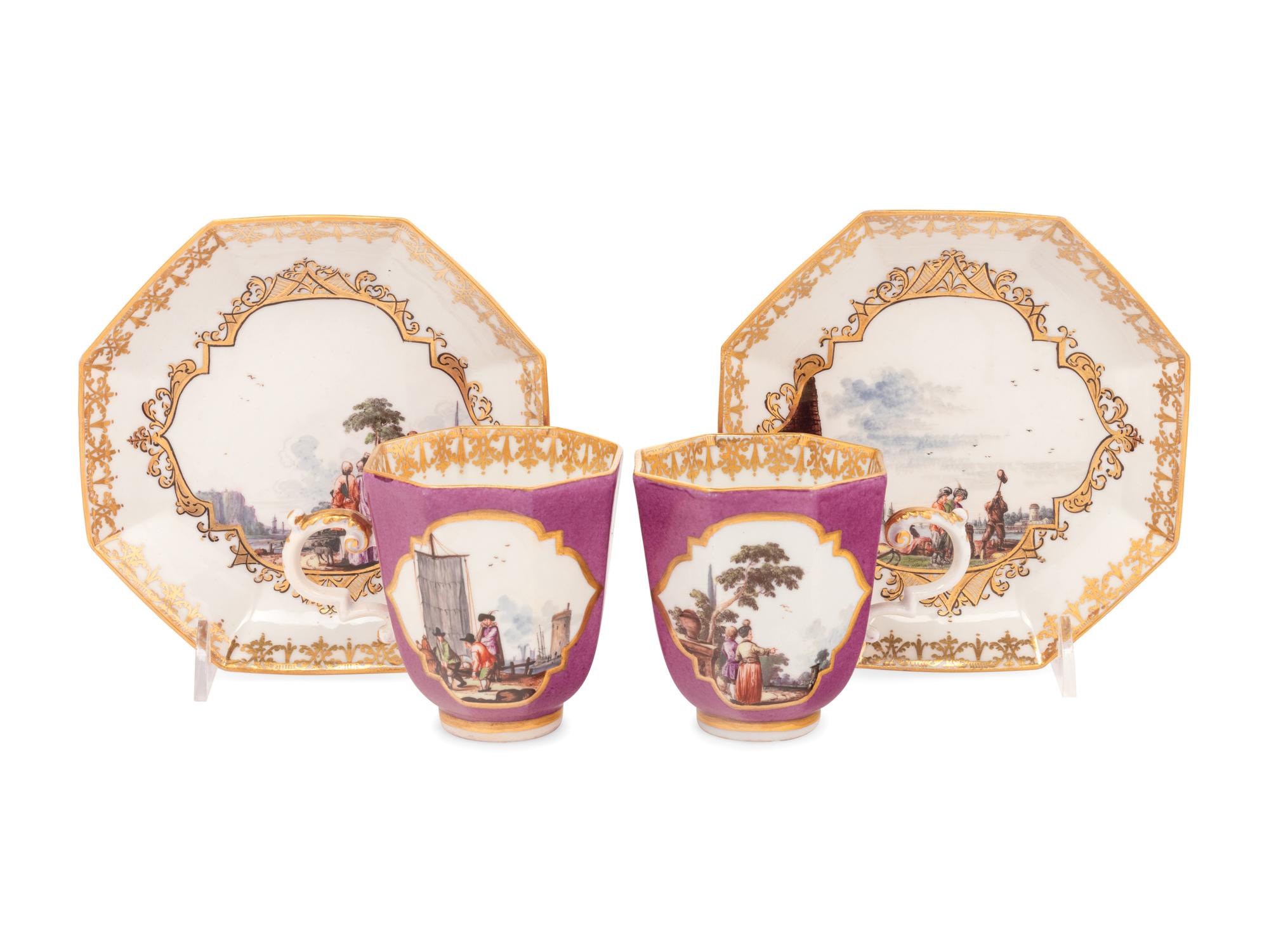 A Pair of Meissen Magenta-Ground Scenic Porcelain Teacups and Saucers