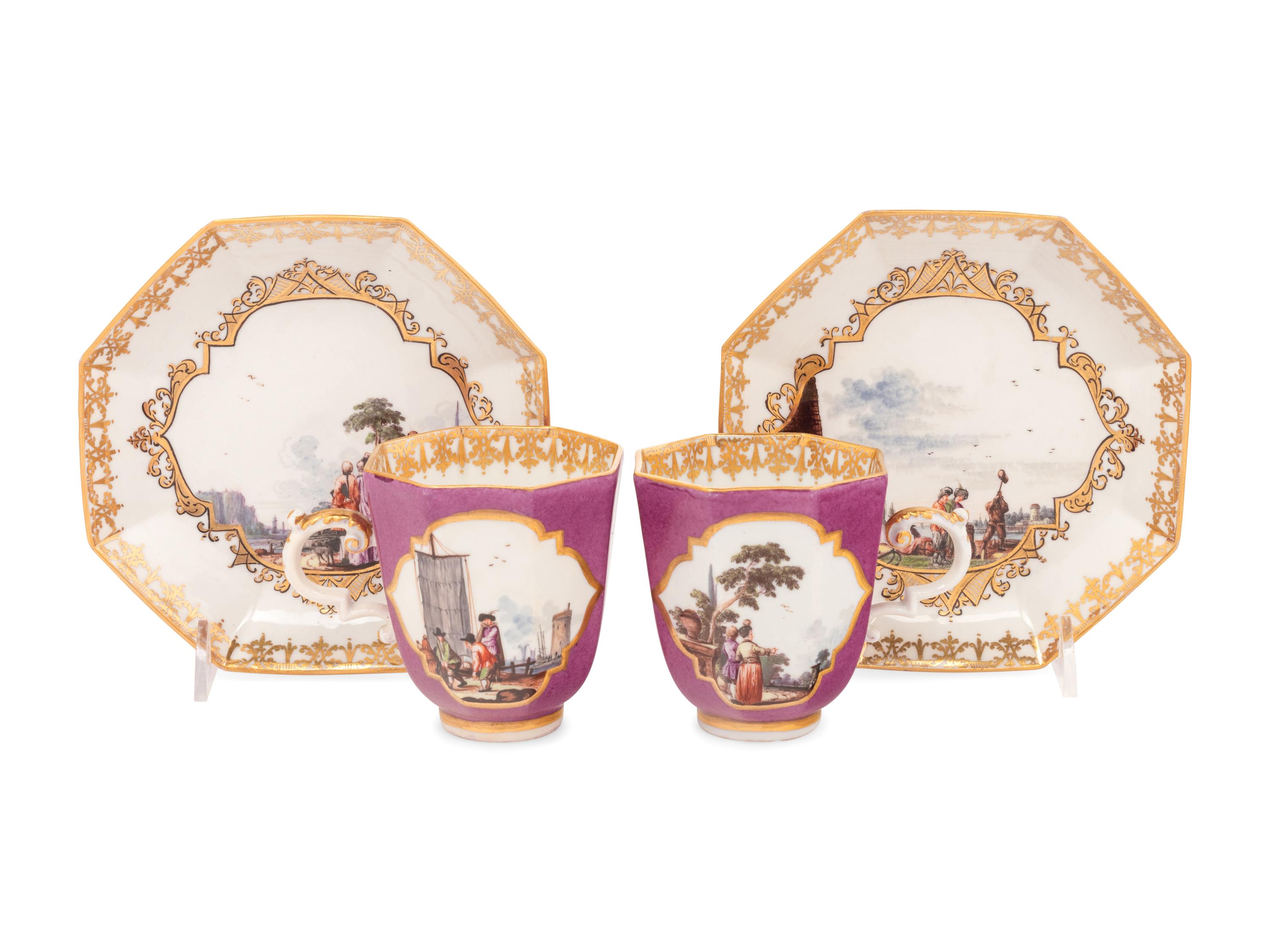 A Pair of Meissen Magenta-Ground Scenic Porcelain Teacups and Saucers
