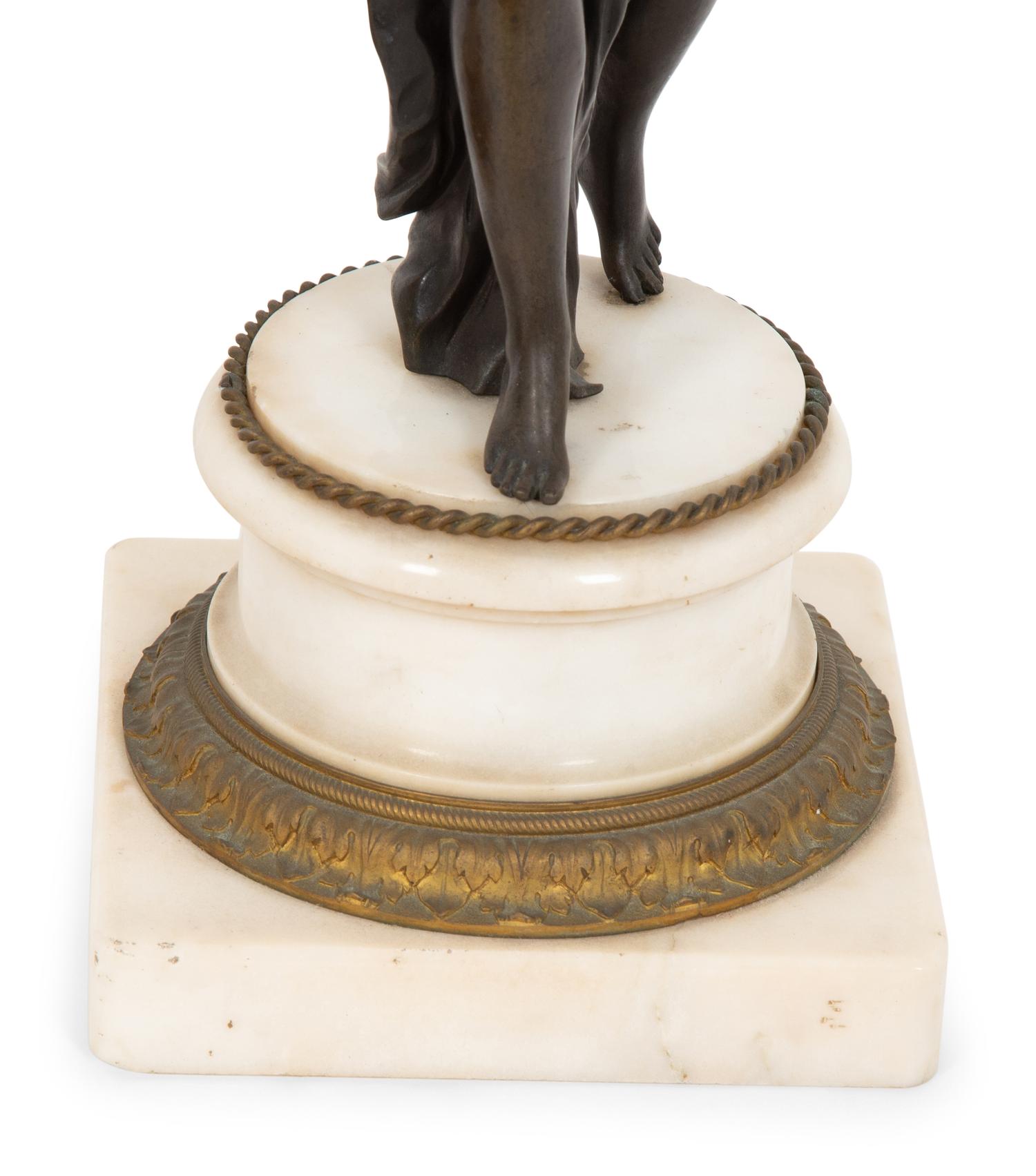 A Pair of French Empire Style Gilt and Patinated Bronze Figural Four-Light Candelabra