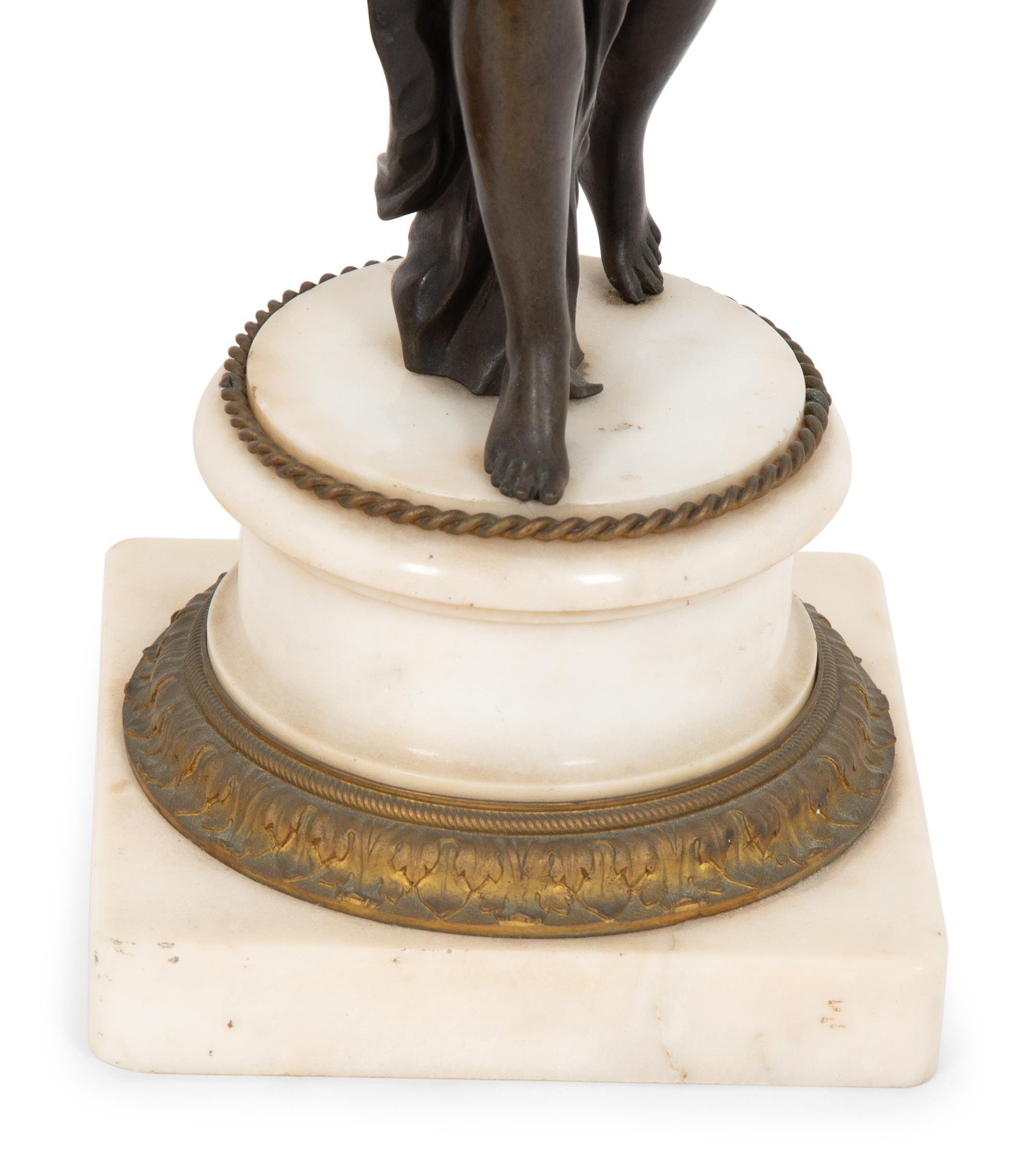 A Pair of French Empire Style Gilt and Patinated Bronze Figural Four-Light Candelabra