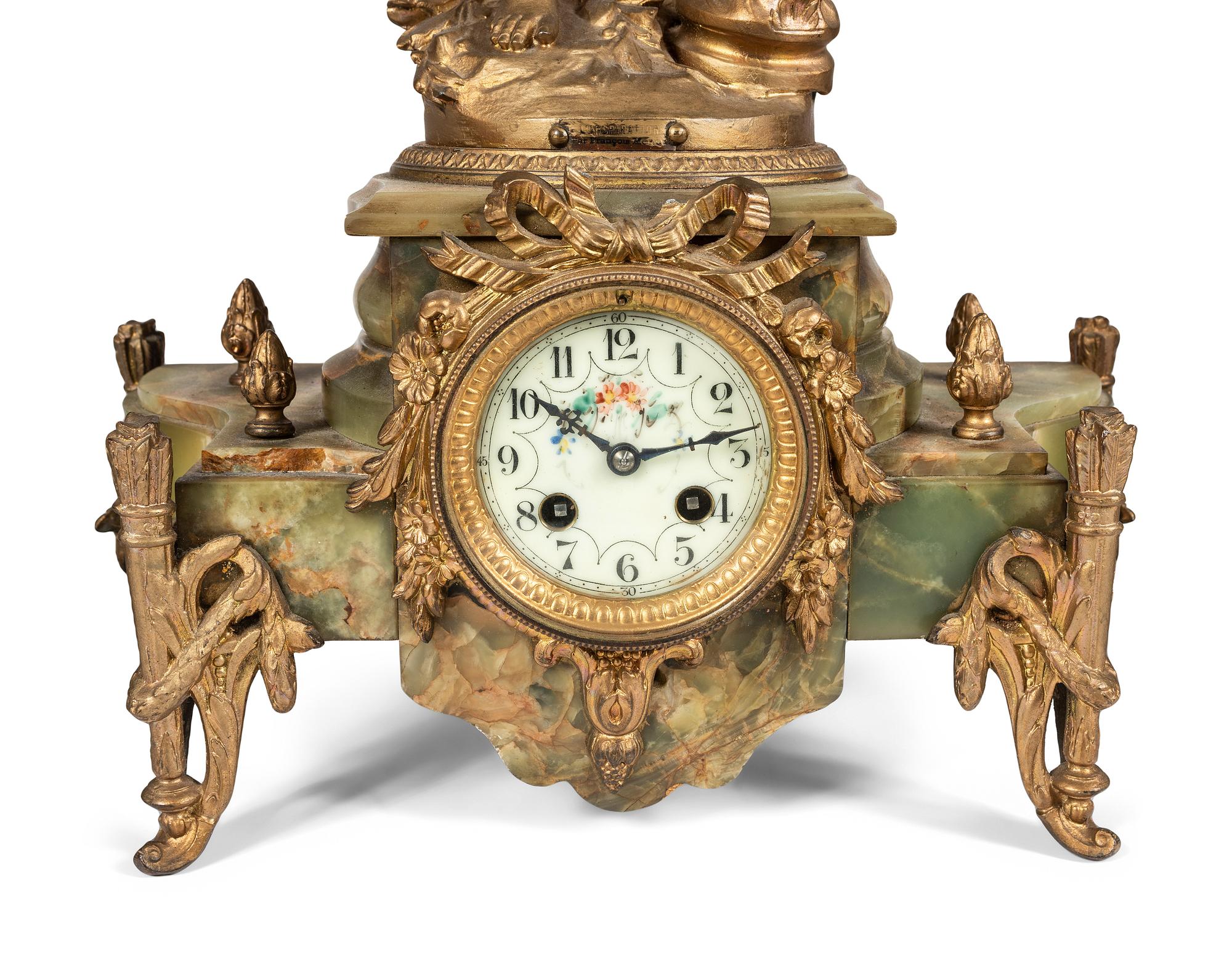 A Neoclassical Gilt Metal and Onyx Clock Garniture