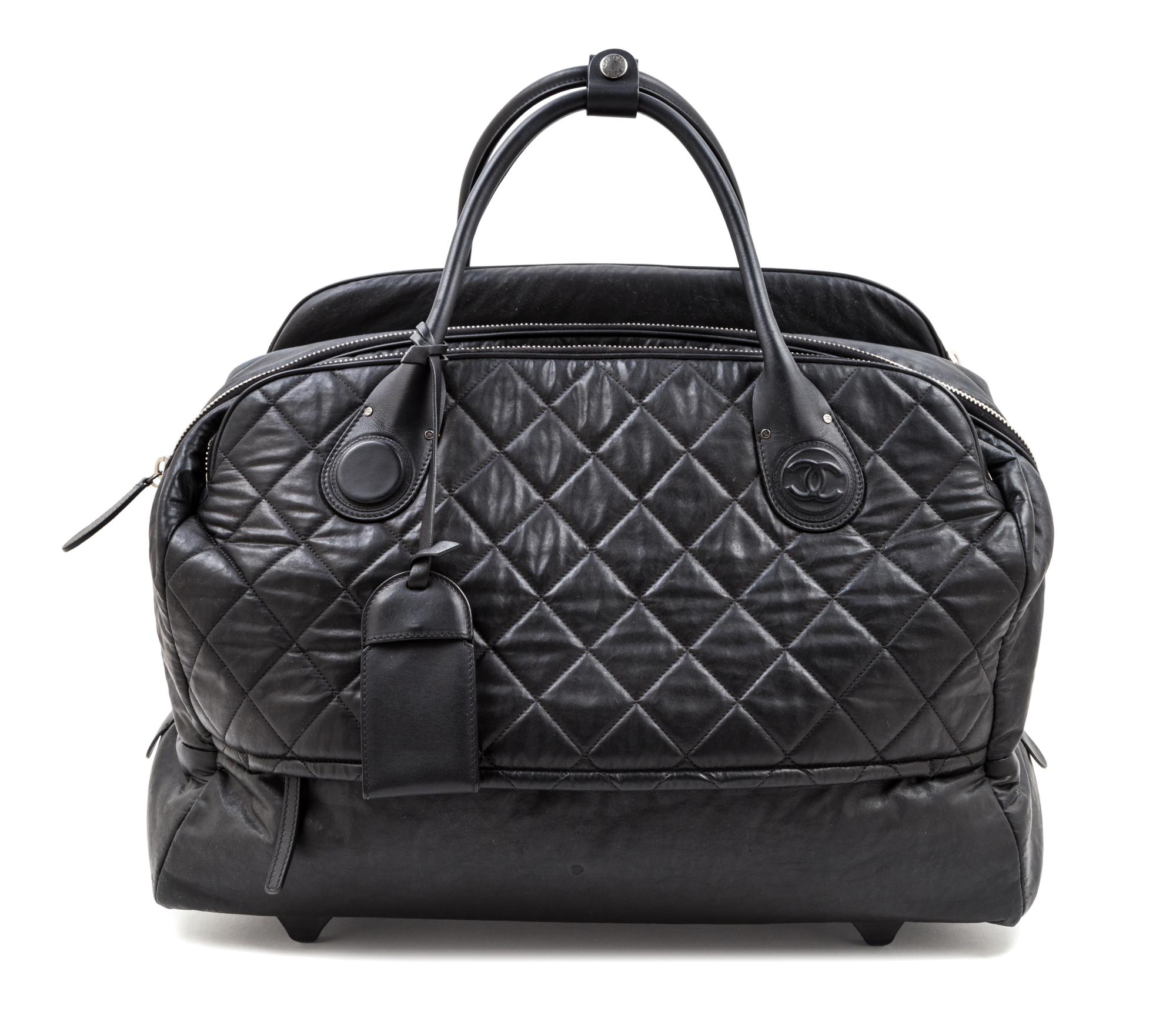 A Chanel Black Quilted Weekender Roller Bag, 19" x 13.5" x 8.5"; Top handle 7''.