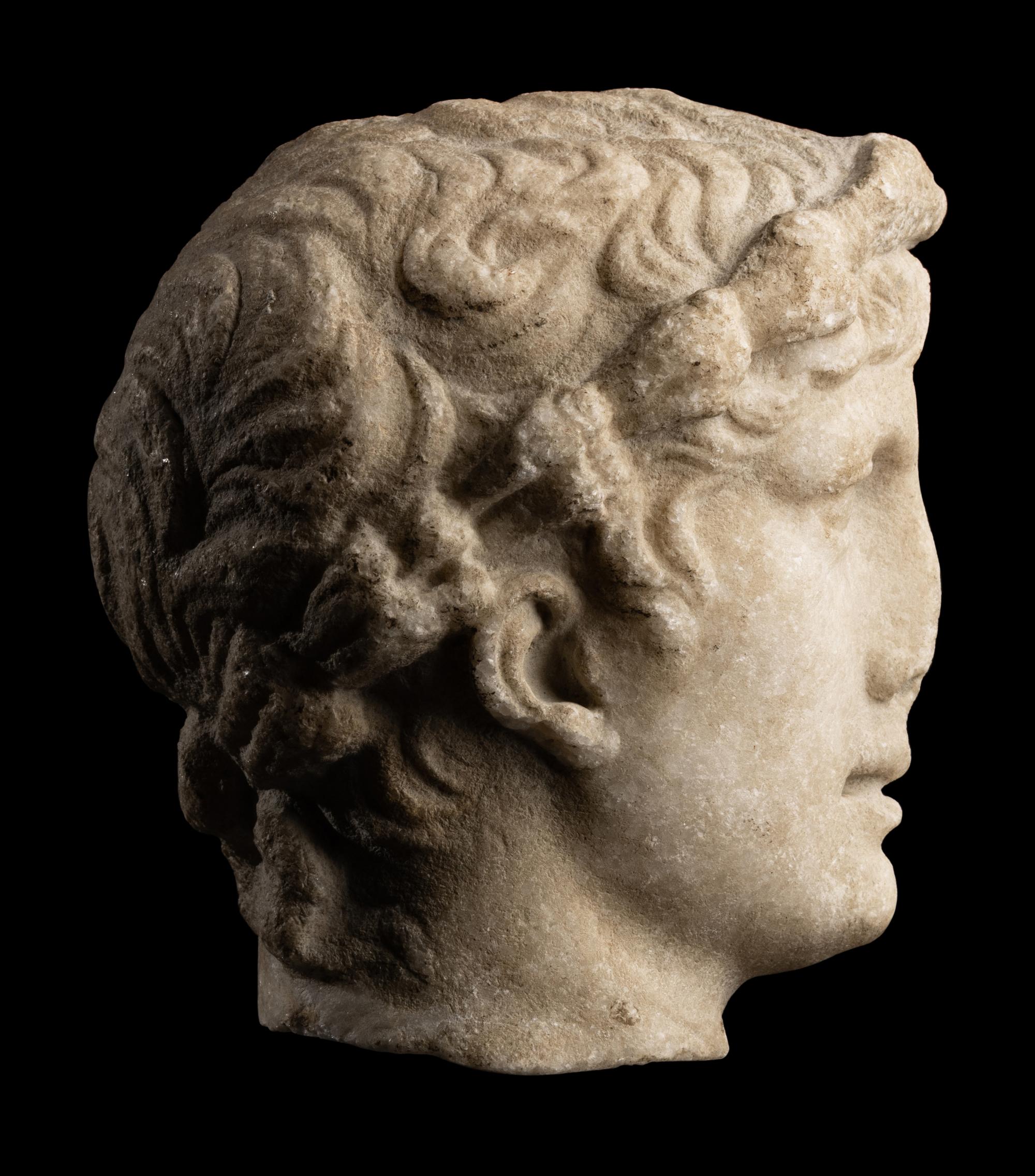 A Roman Marble Head of a Youth with Laurel Wreath