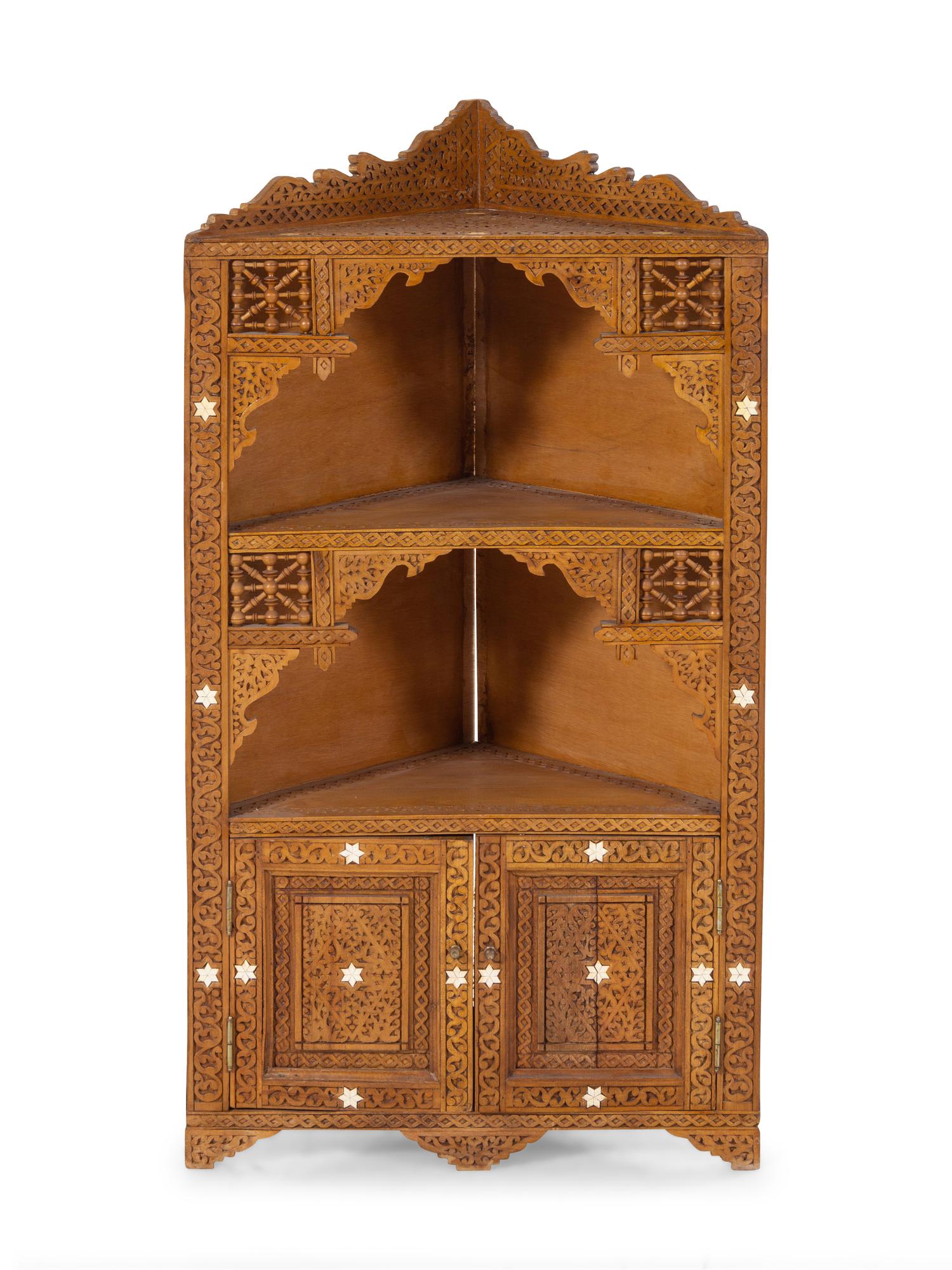 An Egyptian Carved and Inlaid Corner Cabinet