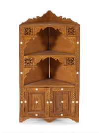 An Egyptian Carved and Inlaid Corner Cabinet