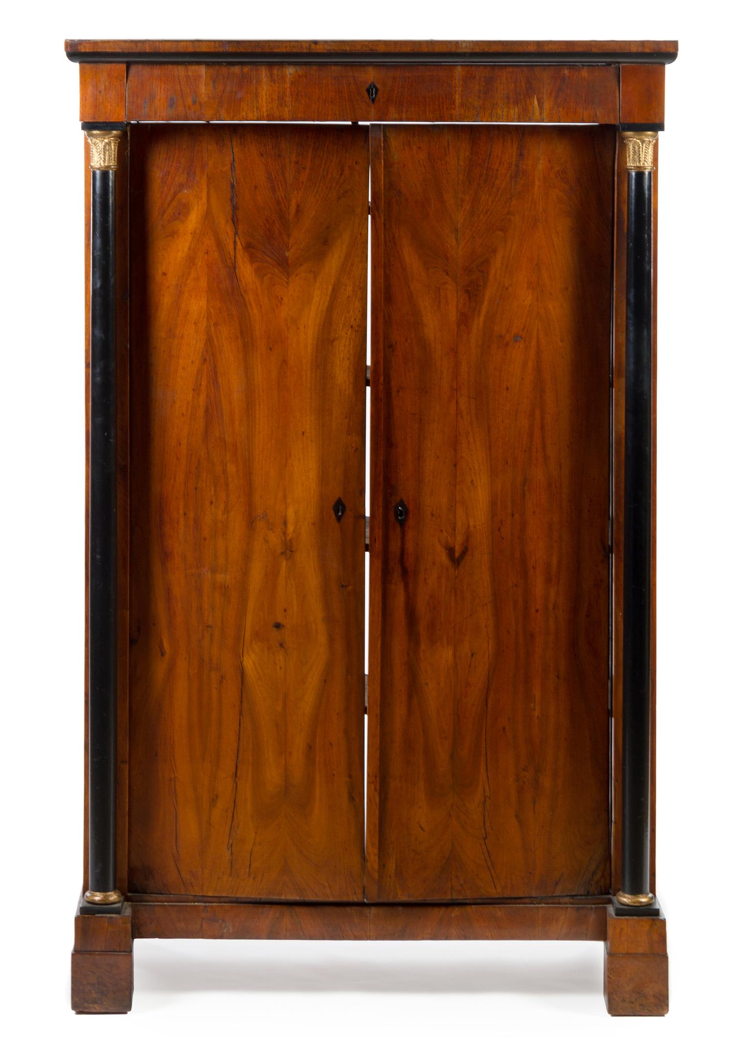 A Biedermeier Gilt Metal Mounted and Part Ebonized Cabinet Height 70 3/4 x width 44 1/2 x depth 21 inches. — 19TH CENTURY
