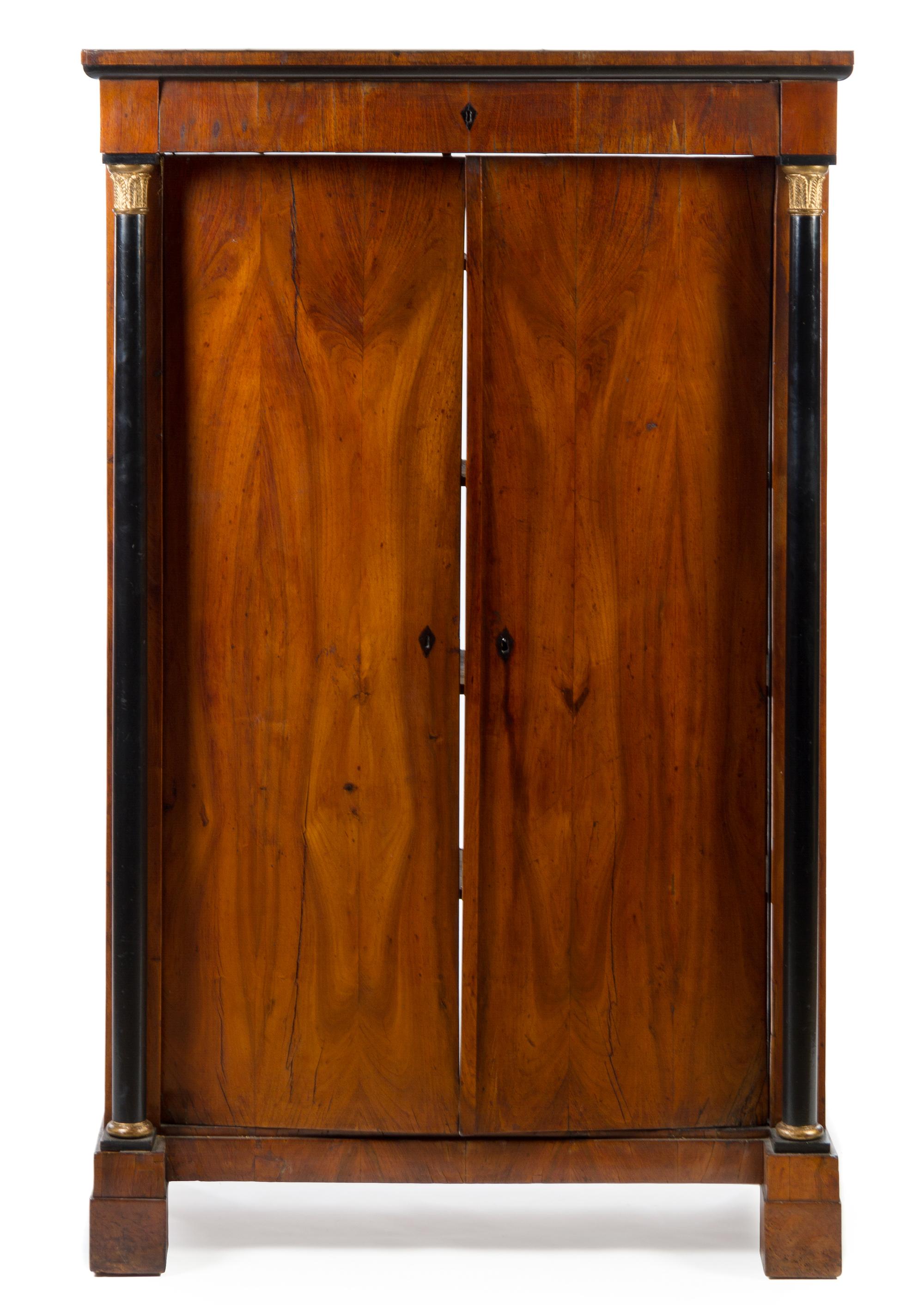 A Biedermeier Gilt Metal Mounted and Part Ebonized Cabinet Height 70 3/4 x width 44 1/2 x depth 21 inches. — 19TH CENTURY