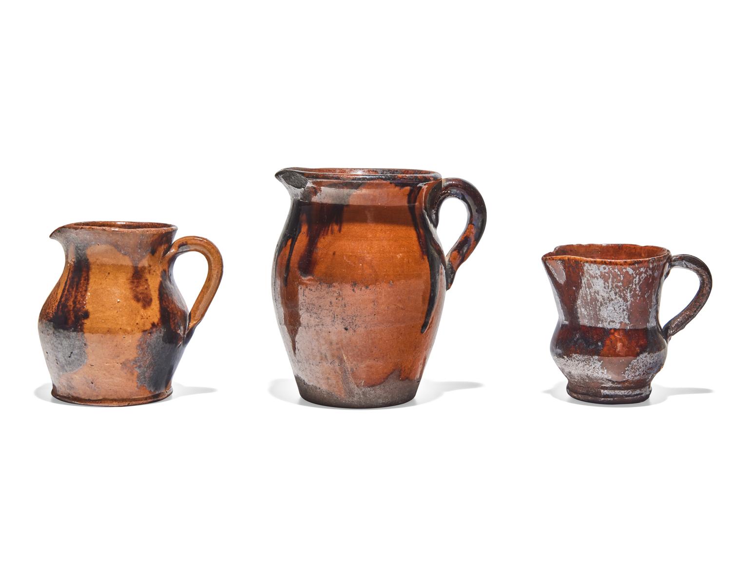 Three Glazed and Manganese Splashed Redware Creamers, 19th Century