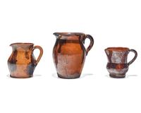 Three Glazed and Manganese Splashed Redware Creamers, 19th Century