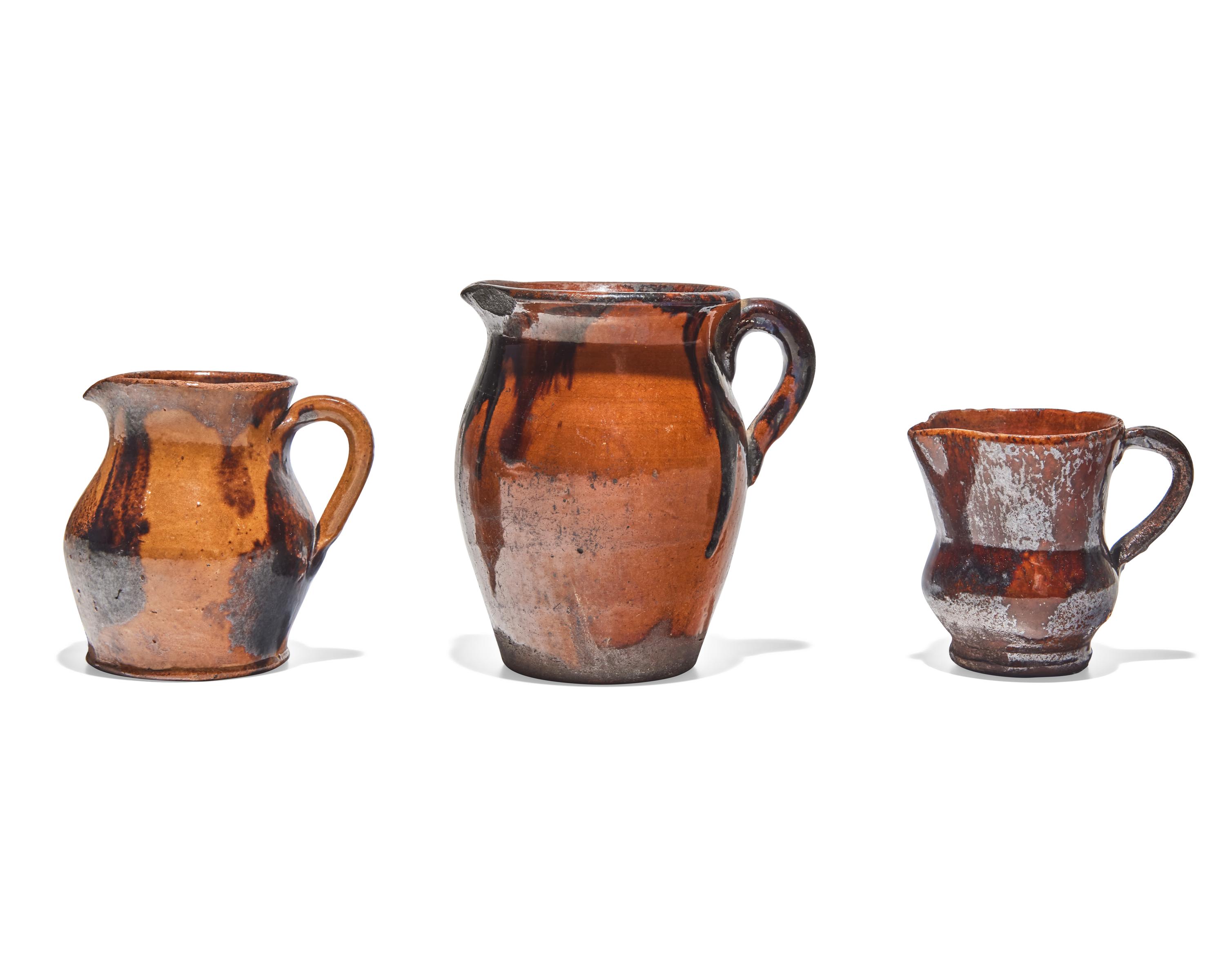 Three Glazed and Manganese Splashed Redware Creamers, 19th Century