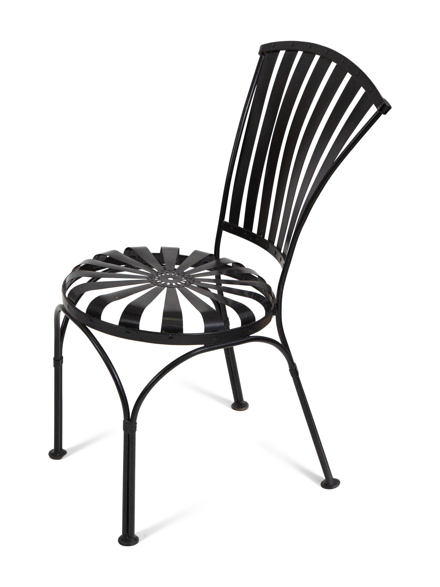 A Spring Steel Garden Table and Eight Chairs by Francois Carre