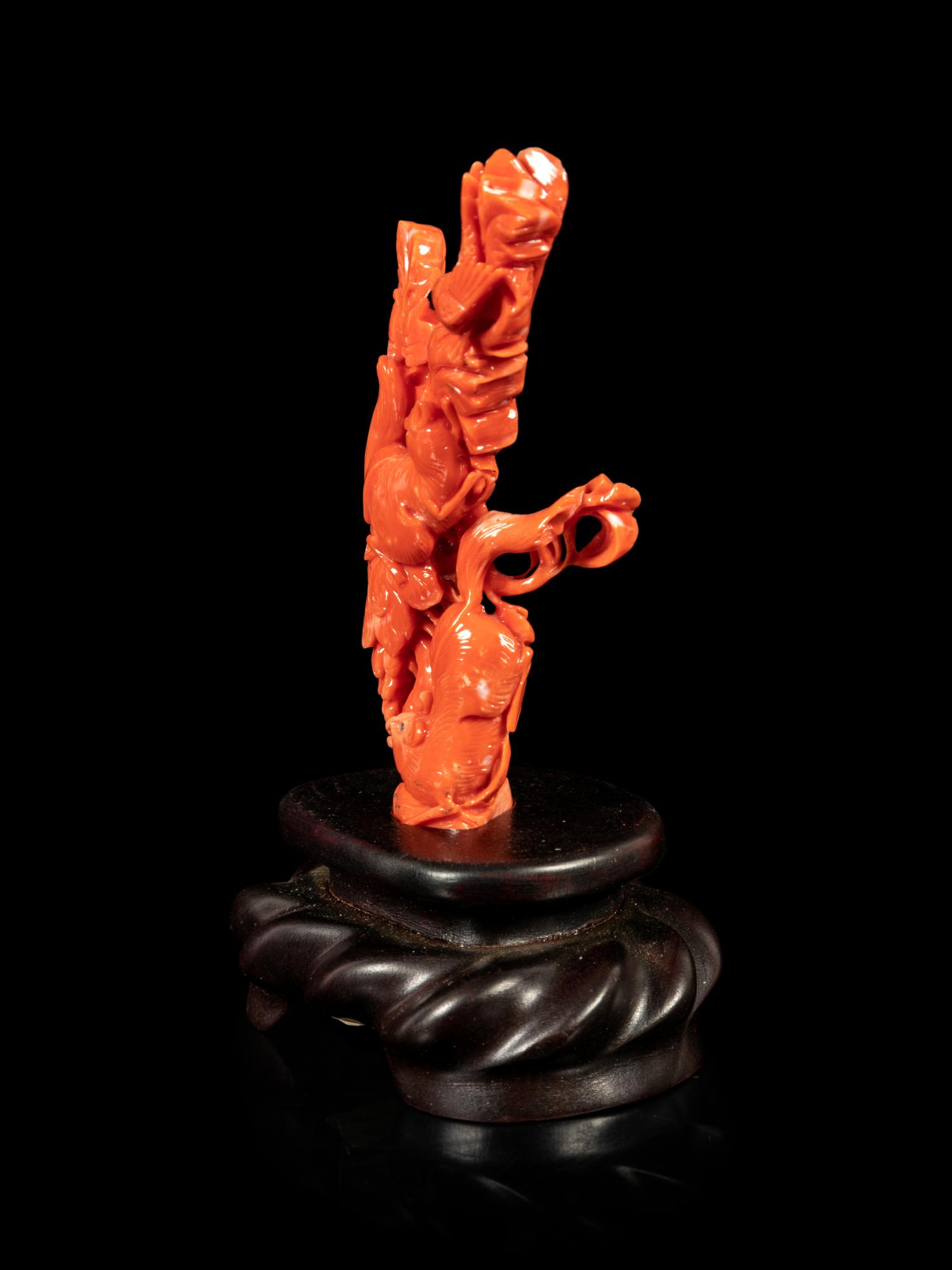 A Red Coral Carving of Squirrels and Grapes