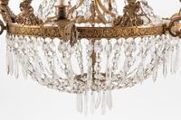 An Empire Style Bronze and Glass Twelve-Light Chandelier