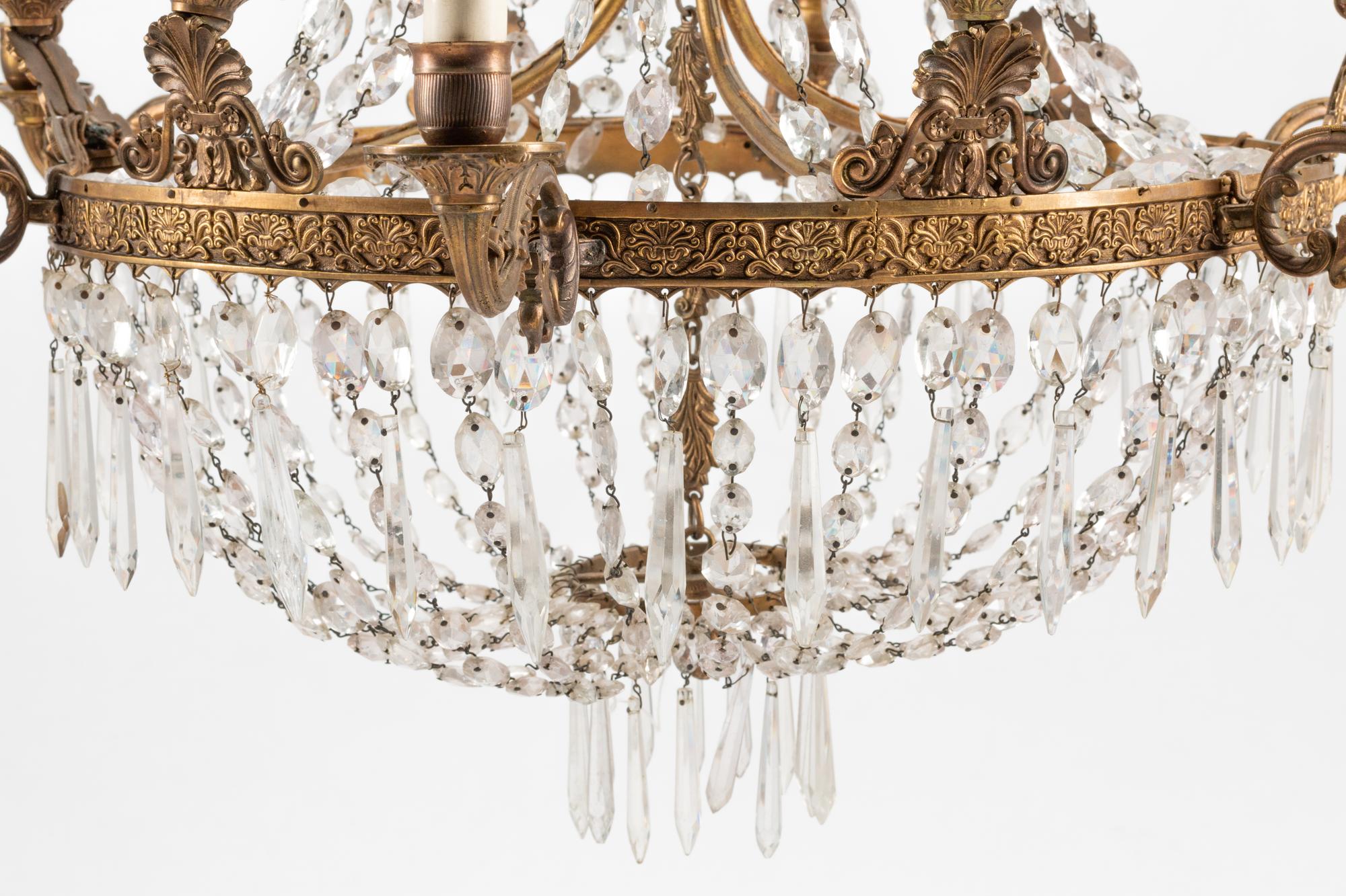 An Empire Style Bronze and Glass Twelve-Light Chandelier