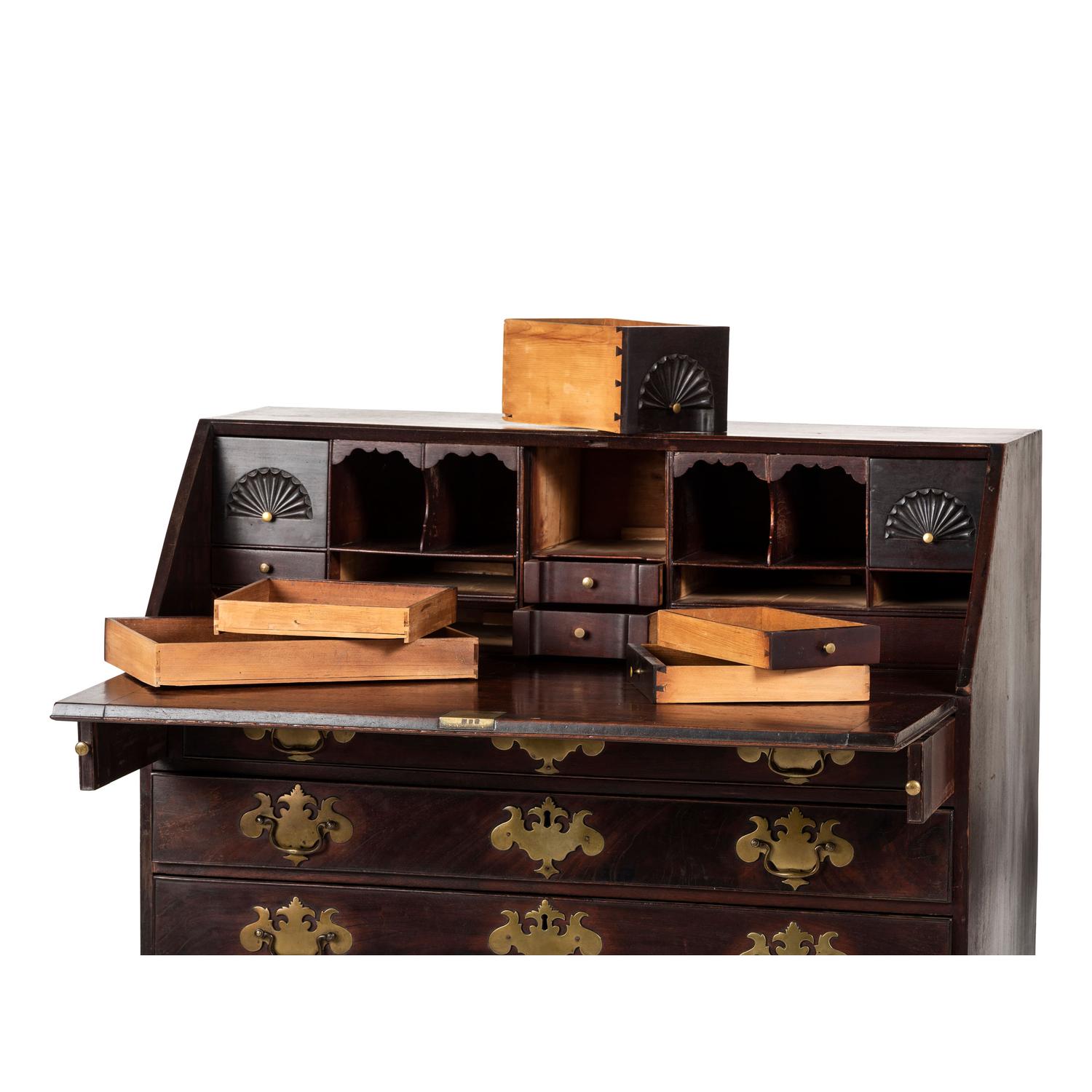 A Chippendale Carved and Figured Mahogany Slant-Front Desk
