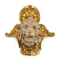 A Pair of English Part Silvered Giltwood Lion Masks — SECOND QUARTER 19TH CENTURY