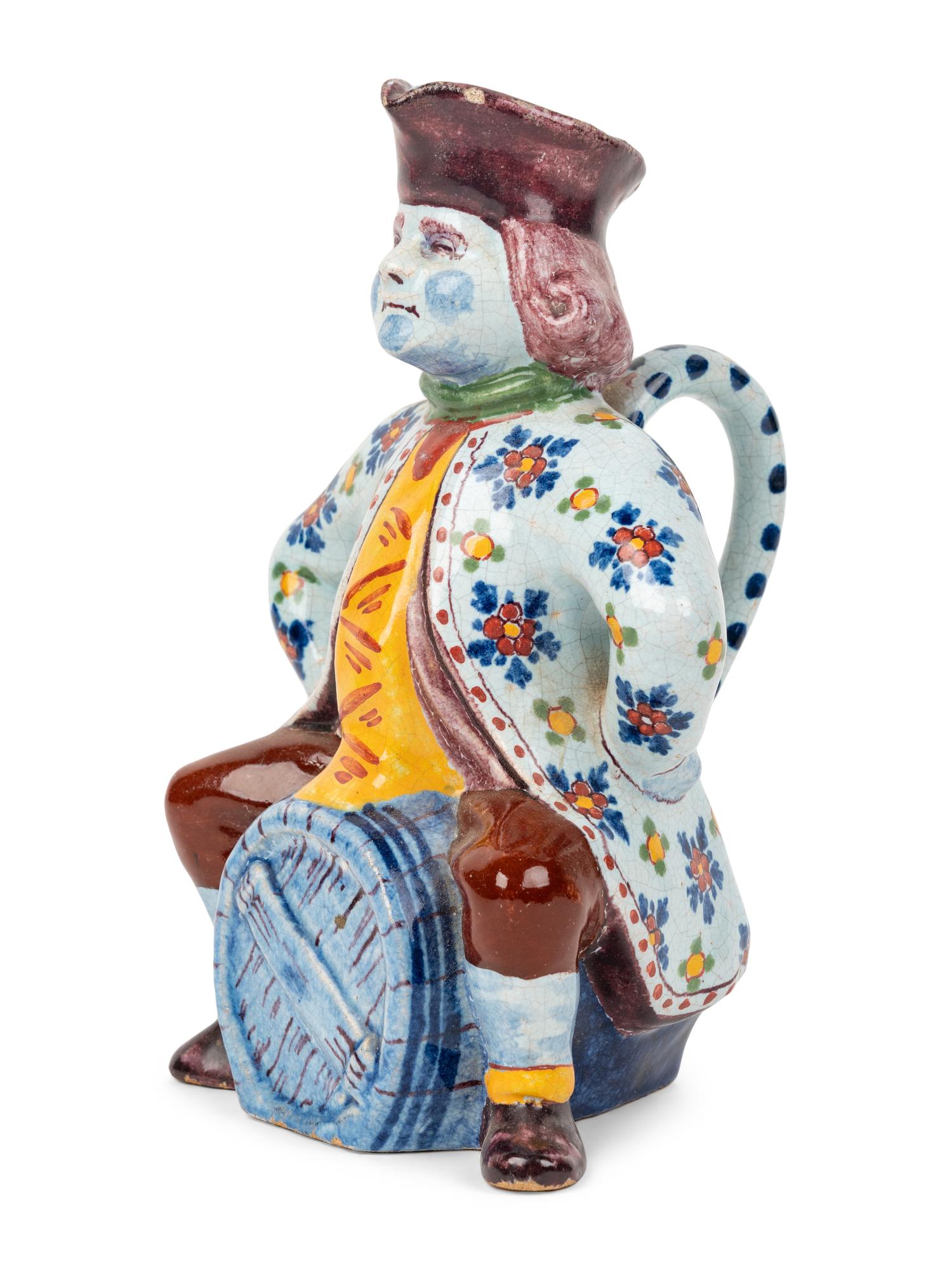 A Faïence "Man on a Barrel" Character Jug