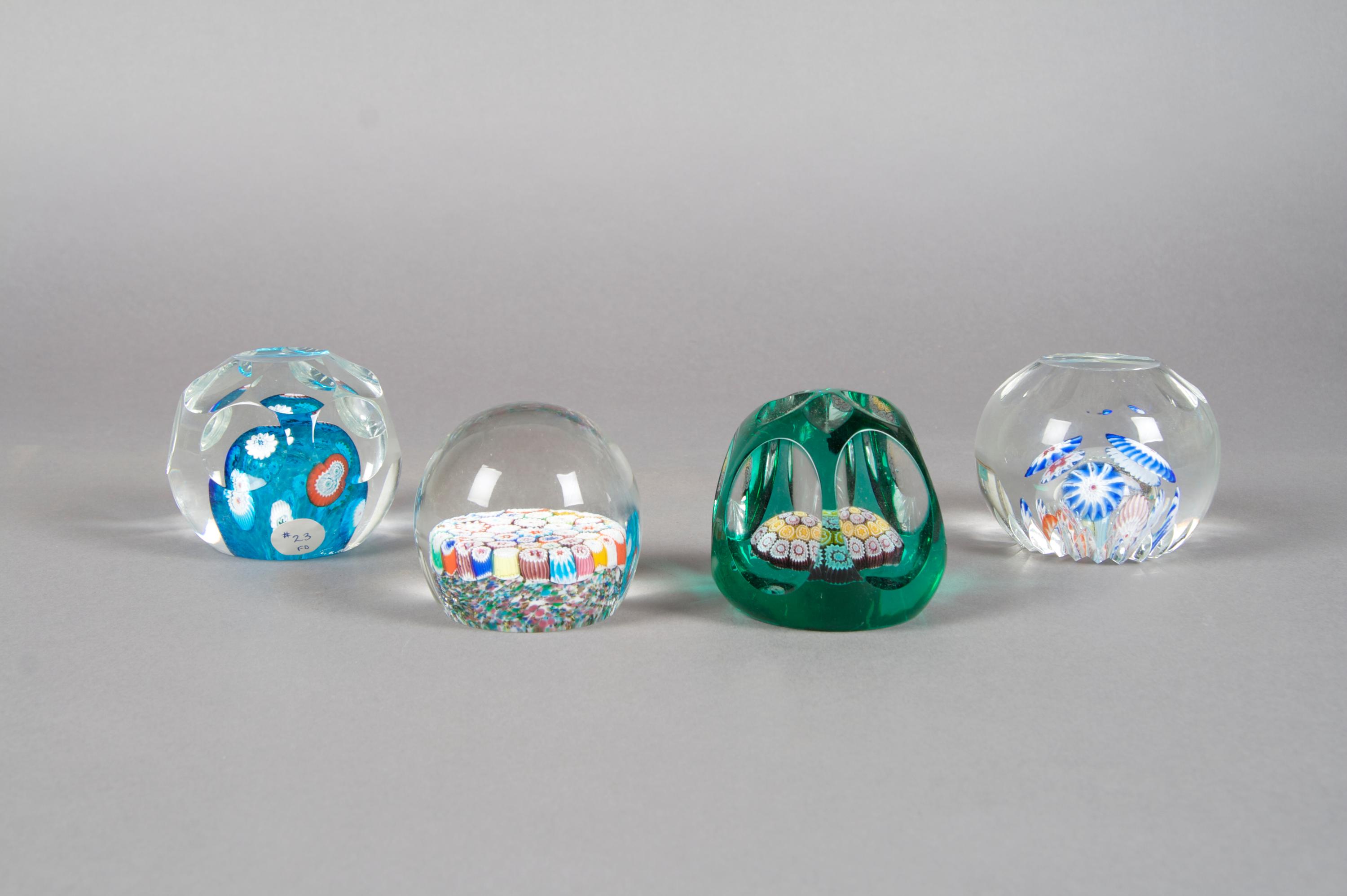 A Collection of Four Paperweights, Diameter of largest 3 1/2 inches.