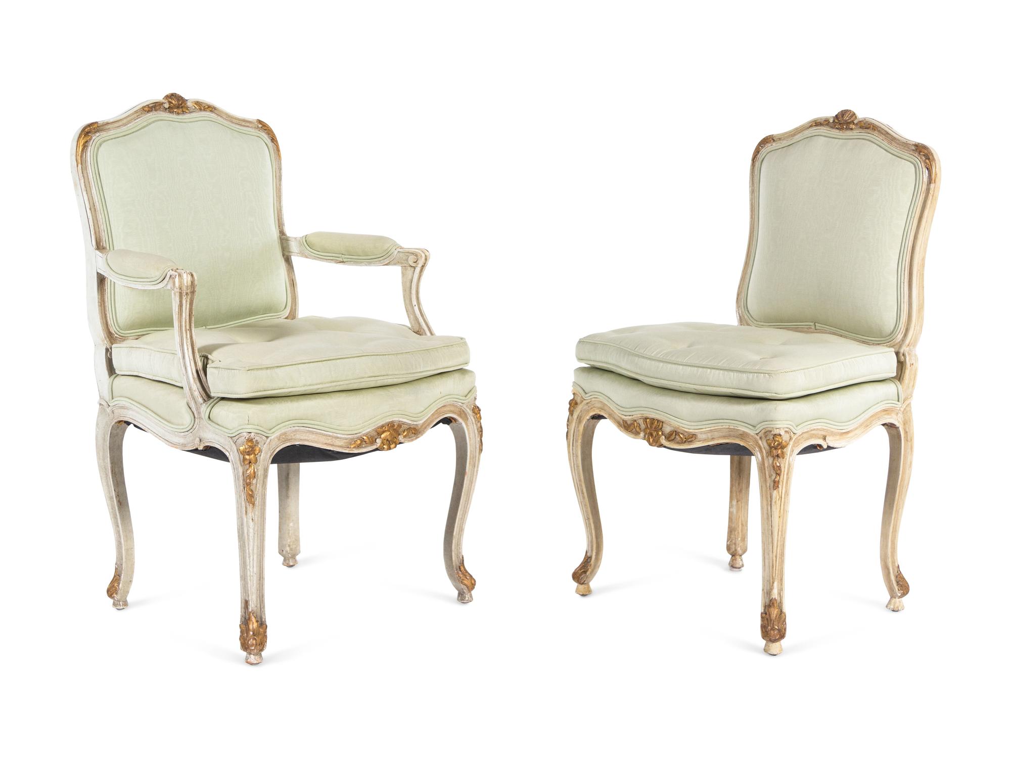 A Set of Twelve Louis XV Style Painted and Parcel Gilt Dining Chairs