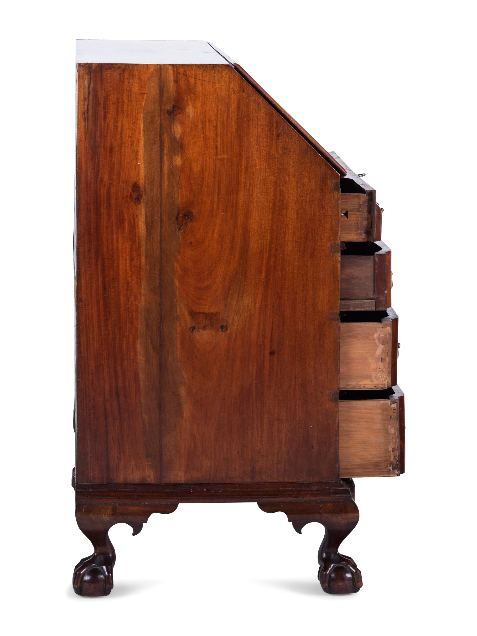 A Chippendale Carved and Figured Mahogany Block-Front Slant-Front Desk