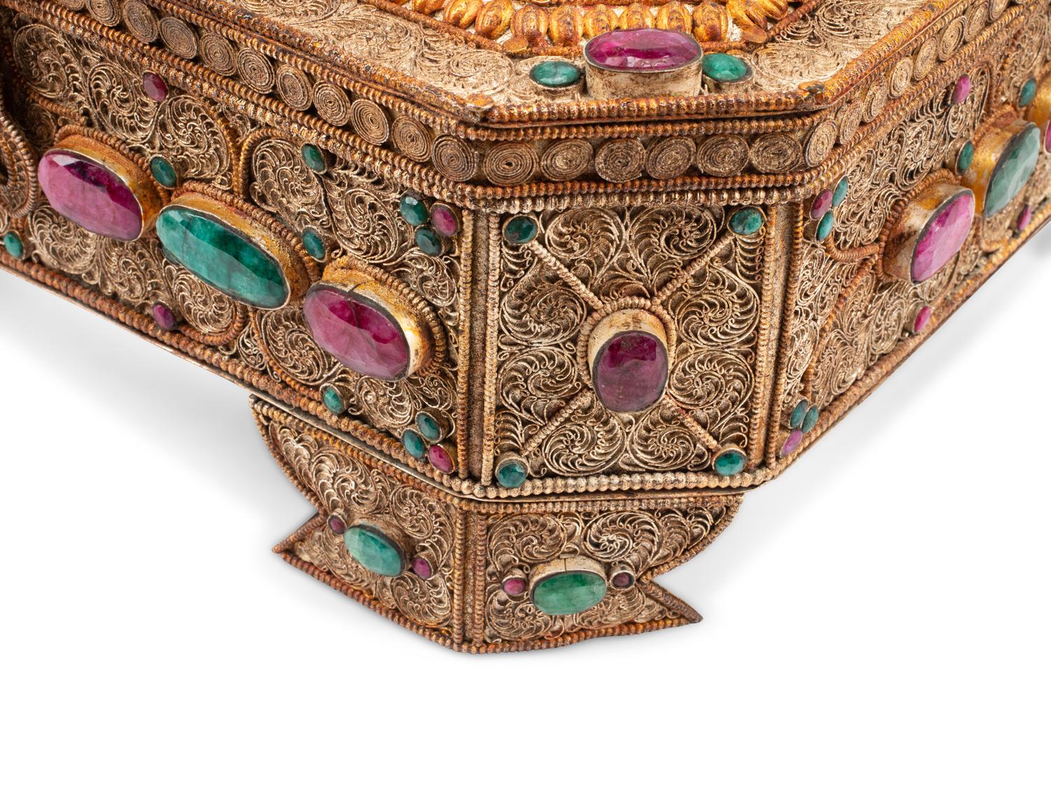 An Emerald and Ruby Mounted Silvered Metal Filigree Box