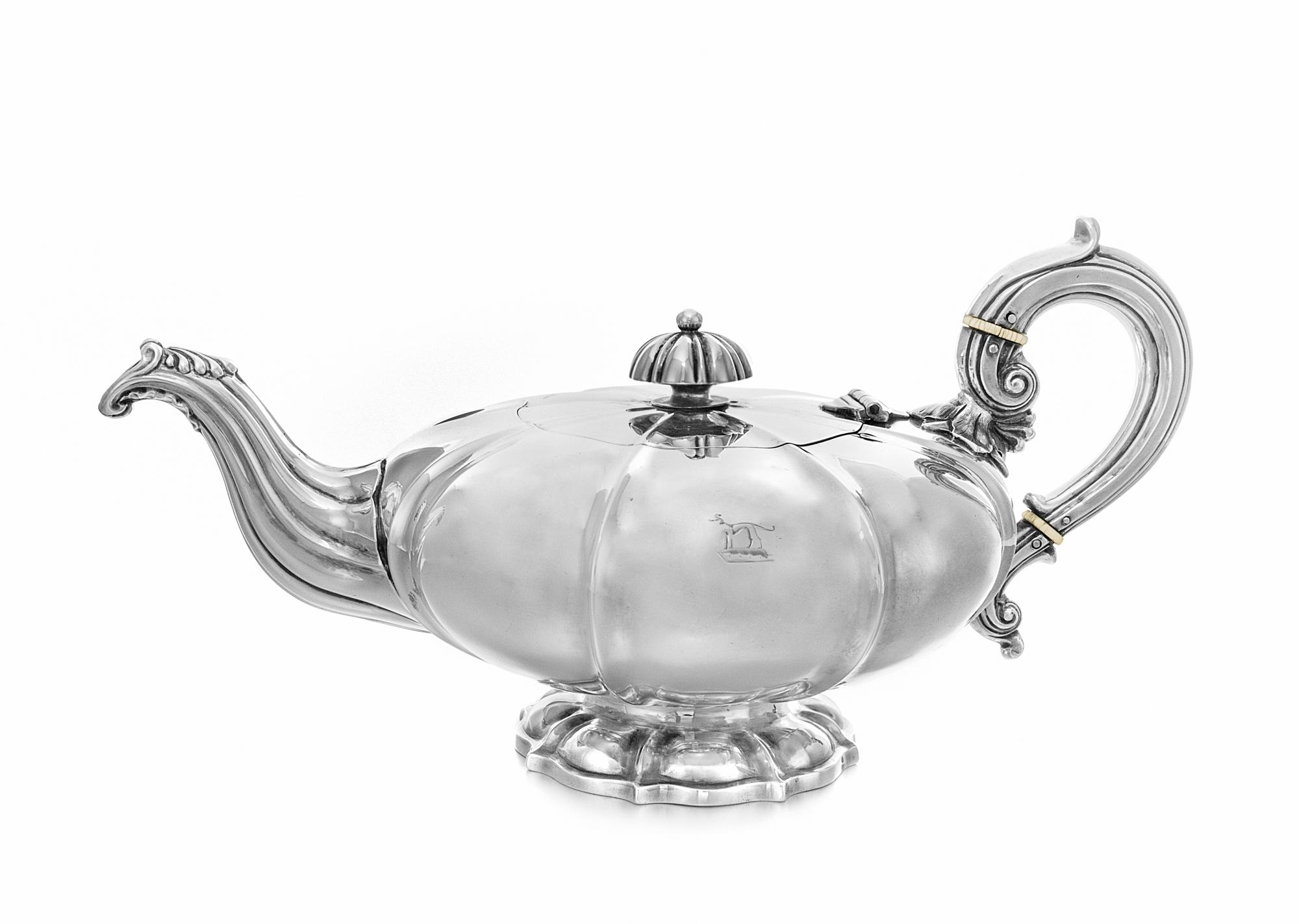 An Irish William IV Silver Teapot, James Fray, Dublin, 1832, of squat form, the lobed body worked with an engraved armorial crest.